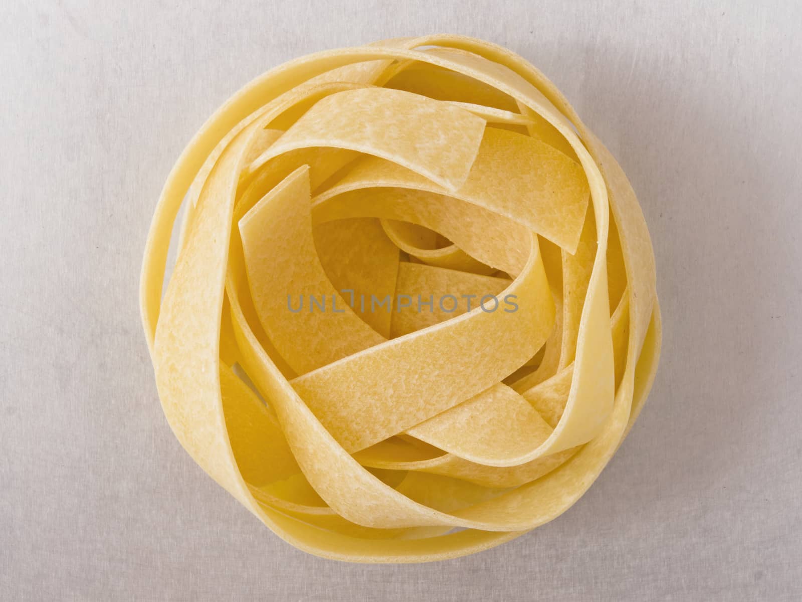 close up of raw uncooked italian pappardelle pasta noodle