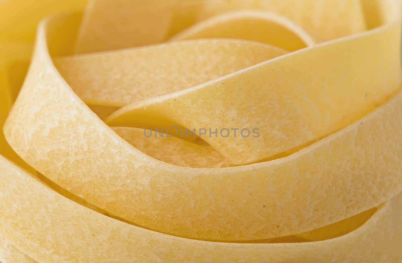 raw uncooked italian pappardelle pasta noodle by zkruger