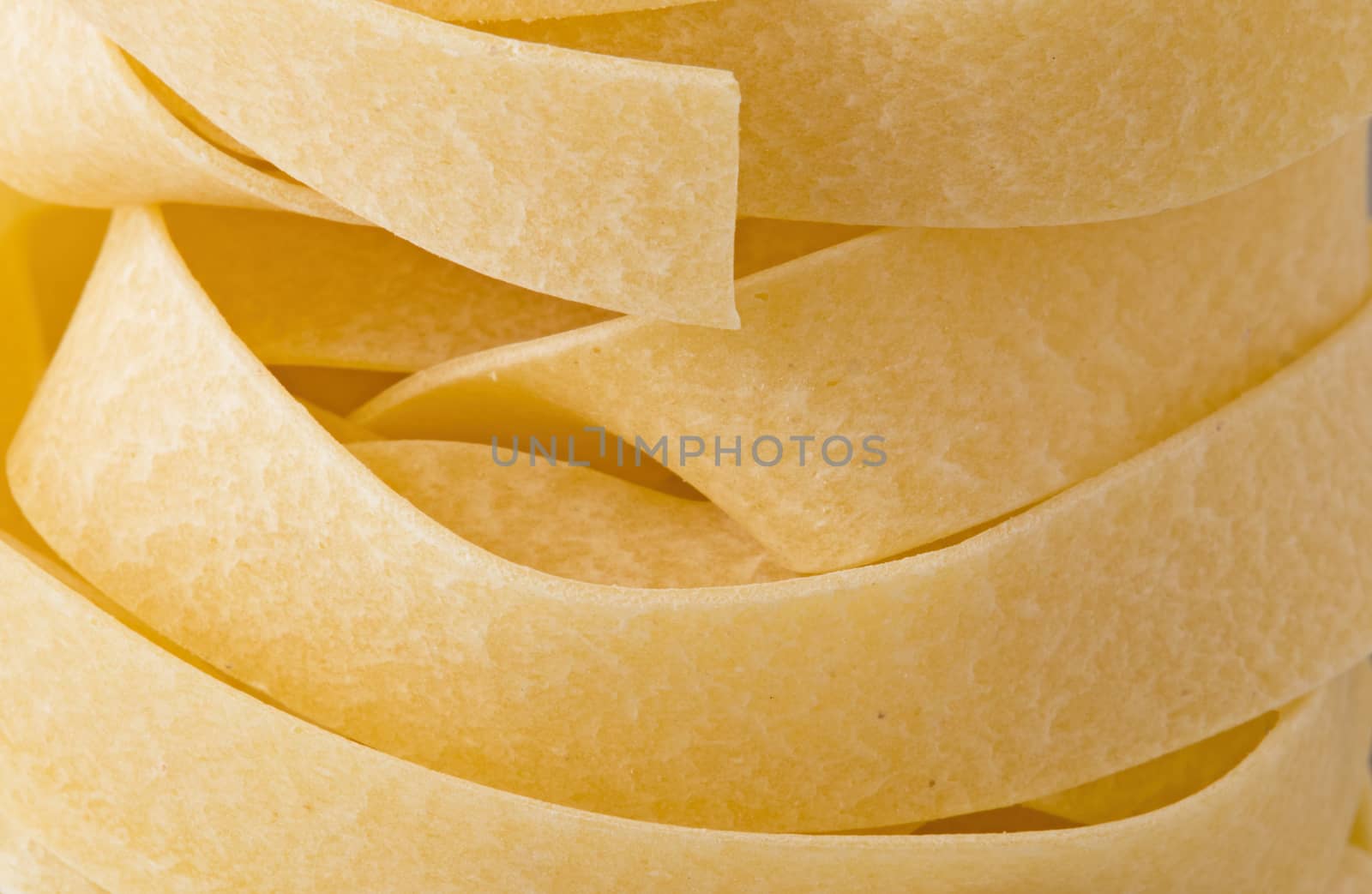 close up of raw uncooked italian pappardelle pasta noodle