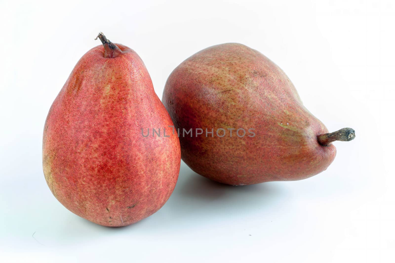 Ripe red pear fruits on white background