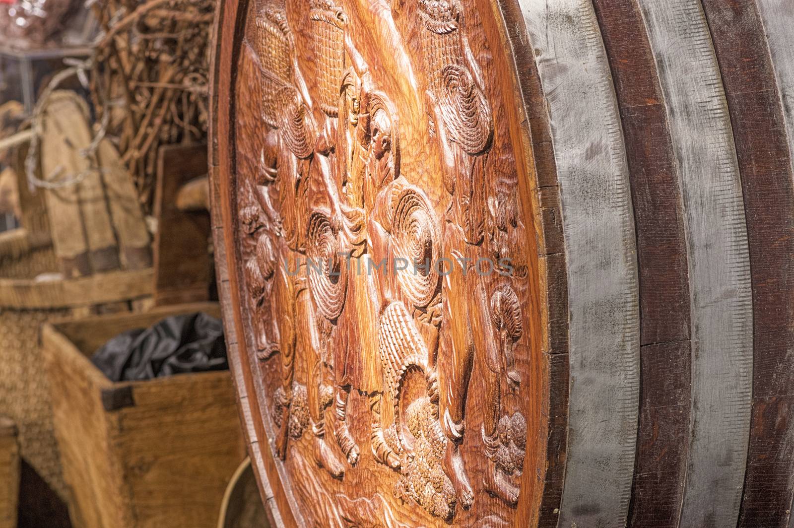 Old wooden wine barrel with drawings on the face is in the cellar