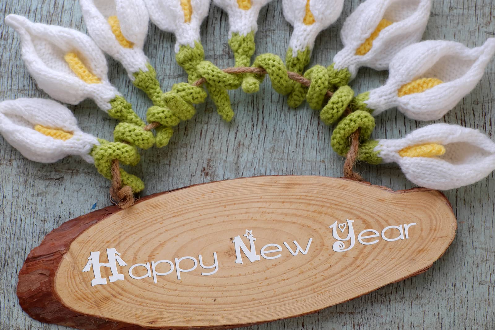 Amazing happy new year background from wood banner with nine of handmade white arum lily knit from yarn, diy home decor to make new year ornament in spring