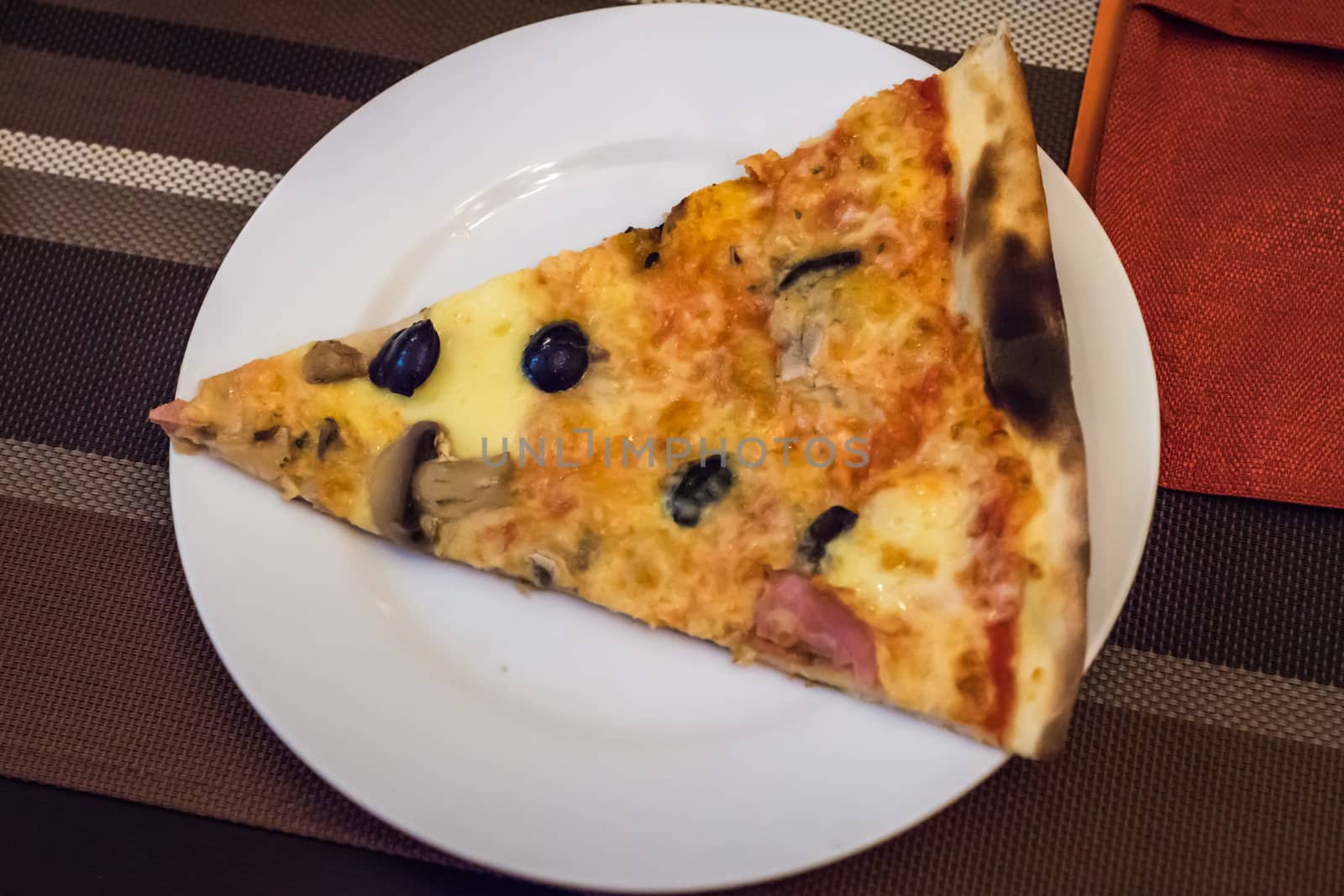 slice of pizza on plate by okskukuruza