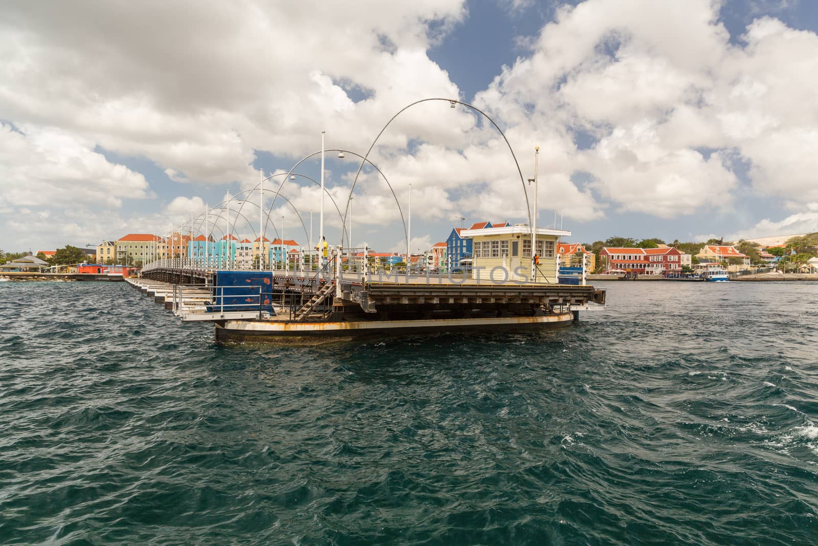 The Queen Emma Bridge is a pontoon bridge across St. Anna Bay in Curaçao. It connects the Punda and Otrobanda quarters of the capital city, Willemstad. The bridge is hinged and opens regularly to enable the passage of oceangoing vessels.