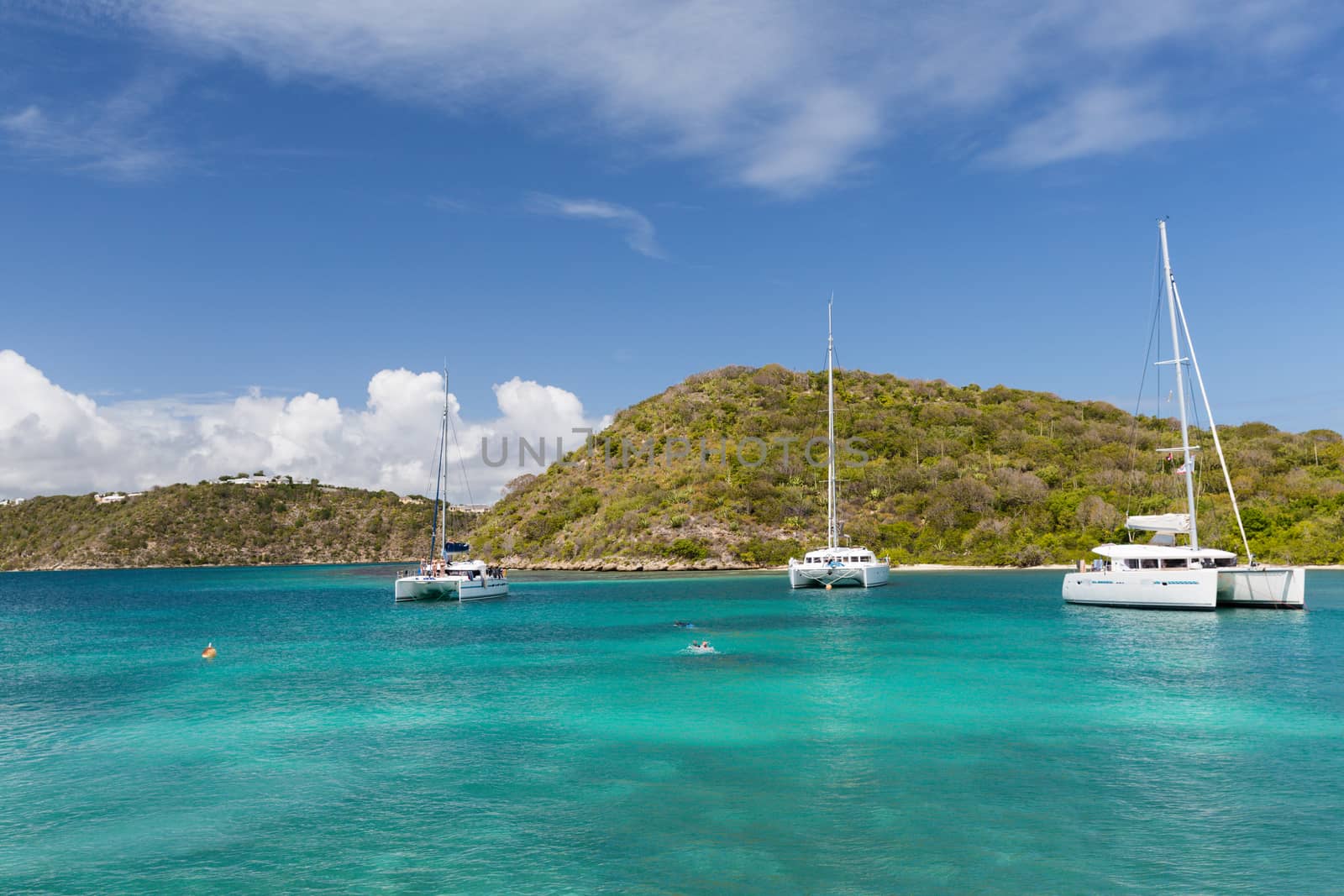 Three catamarans in a calm bay in Antigua