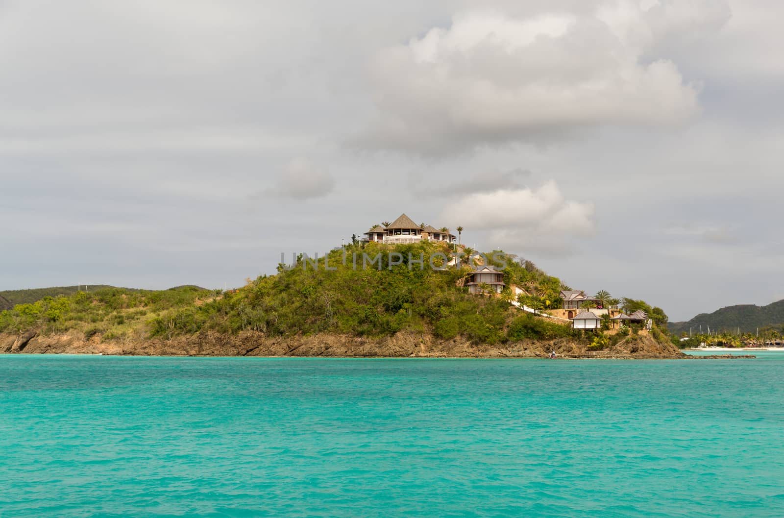 A small series of houses perched on the Antigua coastline