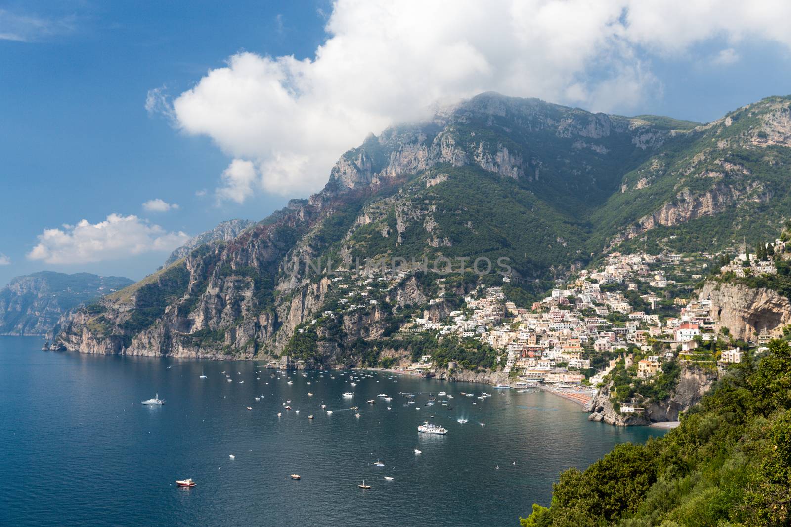 Scenic view of the Amalfi Coast in Italy.  The Amalfi Coast (Italian: Costiera Amalfitana) is a stretch of coastline on the southern coast of the Sorrentine Peninsula in the Province of Salerno in Southern Italy. The Amalfi Coast is a popular tourist destination for the region and Italy as a whole, attracting thousands of tourists annually.  In 1997, the Amalfi Coast was listed as a UNESCO World Heritage Site as a cultural landscape.