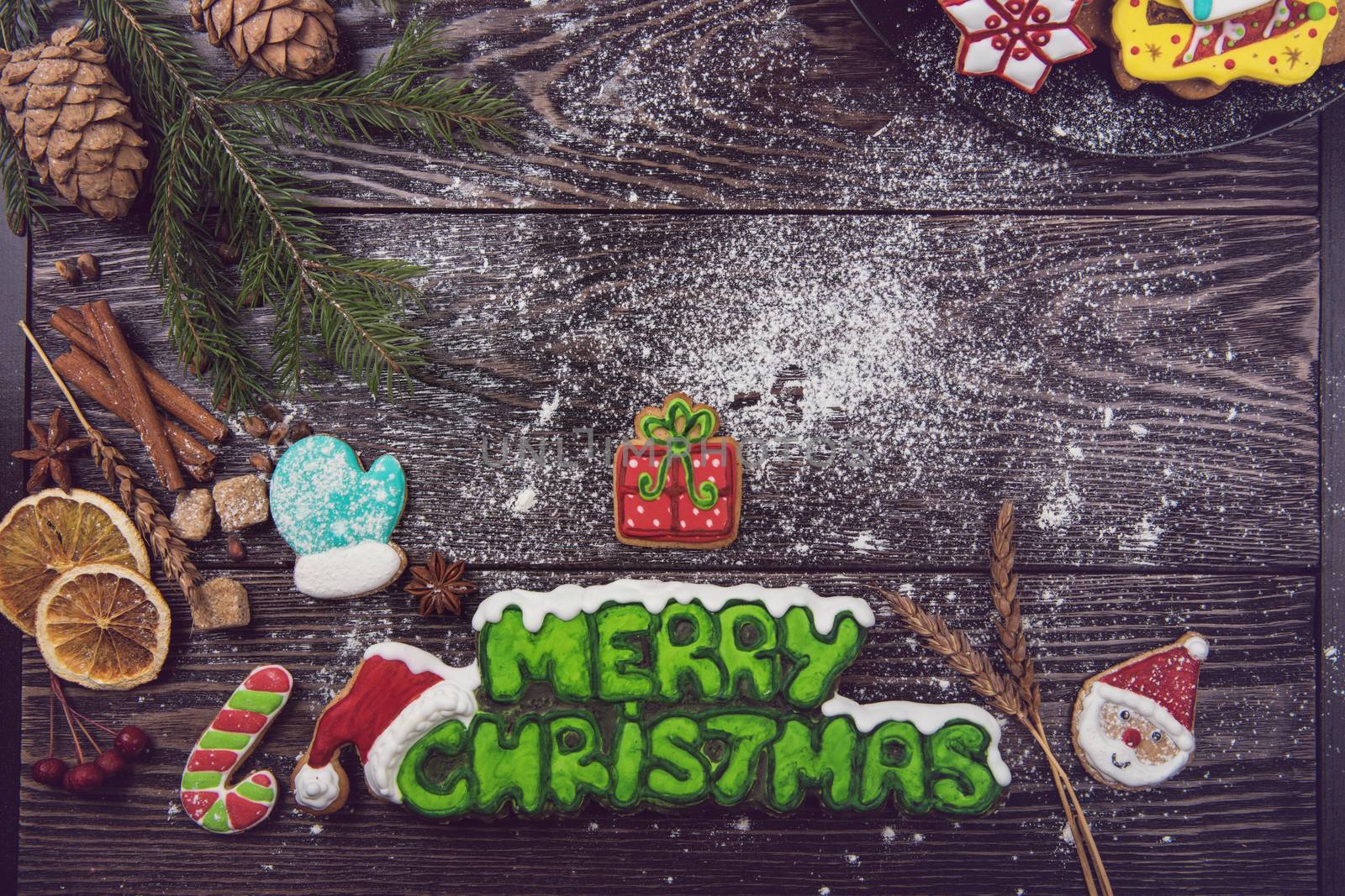 Gingerbreads for new years and christmas on wooden background with space for design