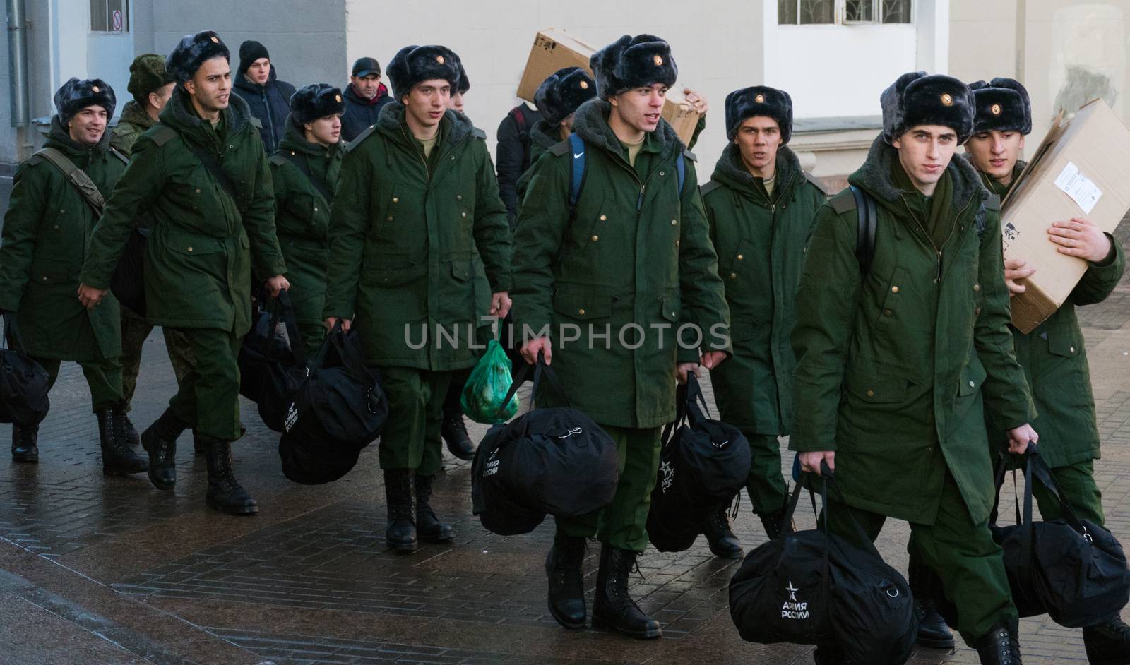 Moscow, December 2016 - The soldiers recruits in green uniforms with boxes go and look