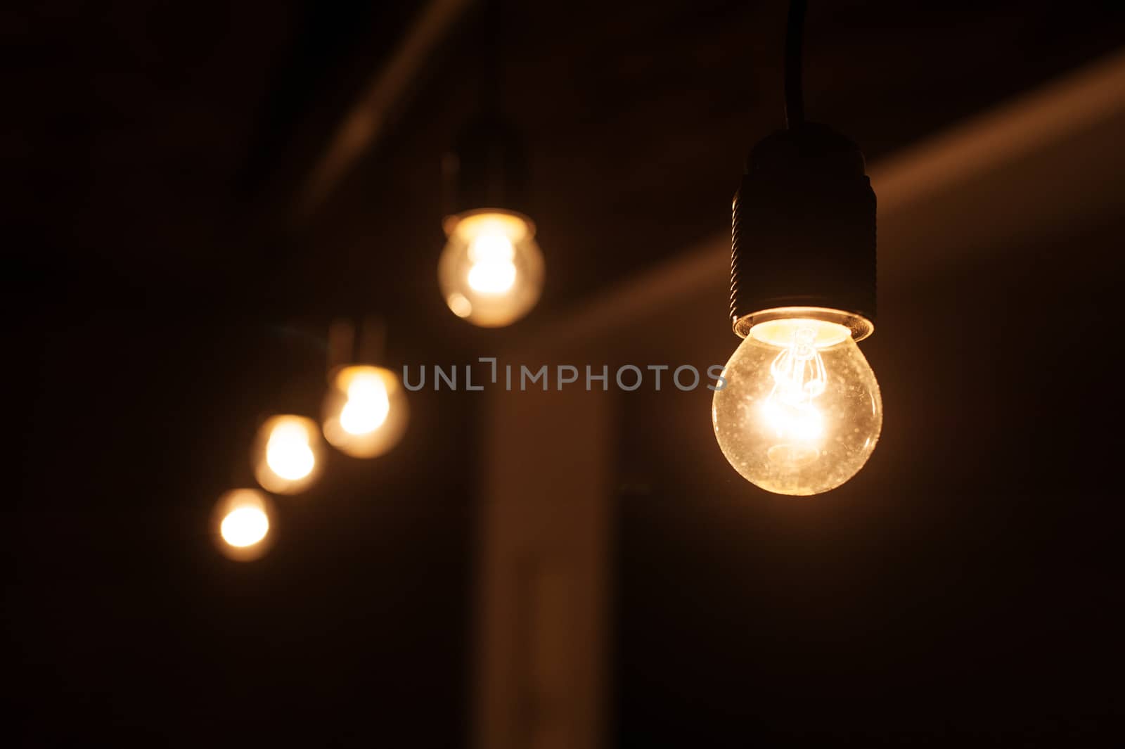 five included light bulbs in a dark room.