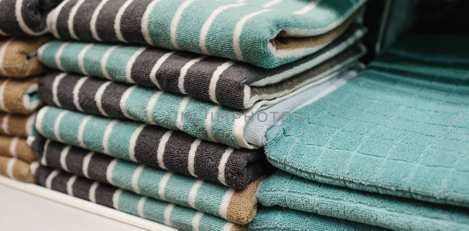 green towels on the shelves in store