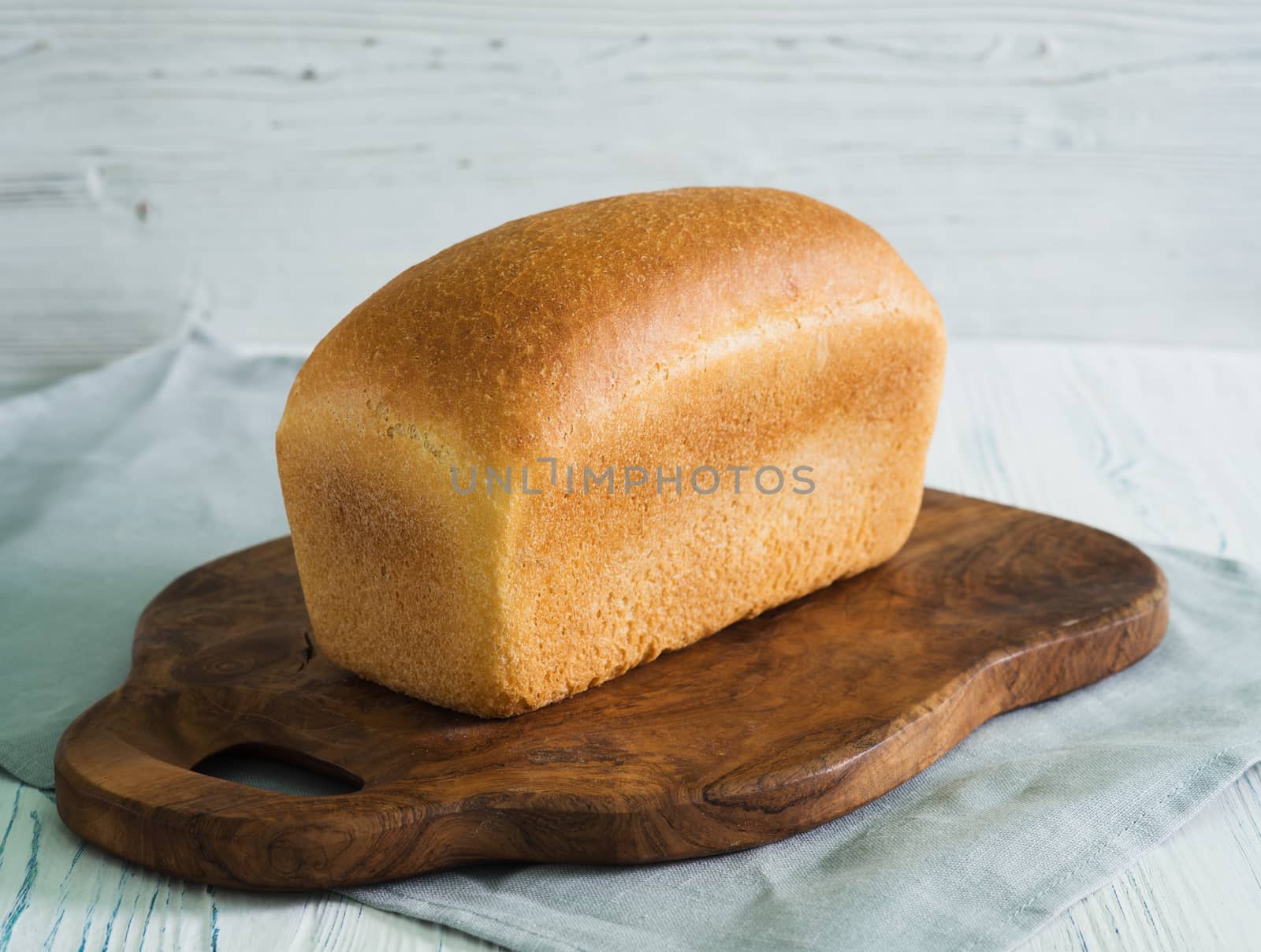Loaf of bread on cutting board by kzen