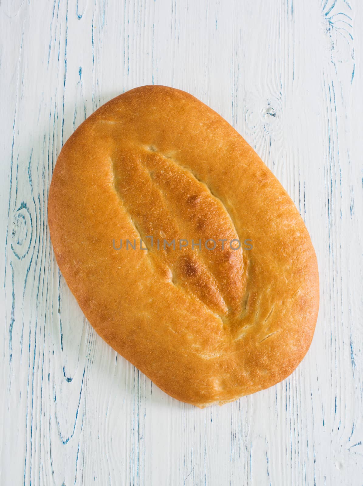 Whole wheat pita bread on wood table by kzen