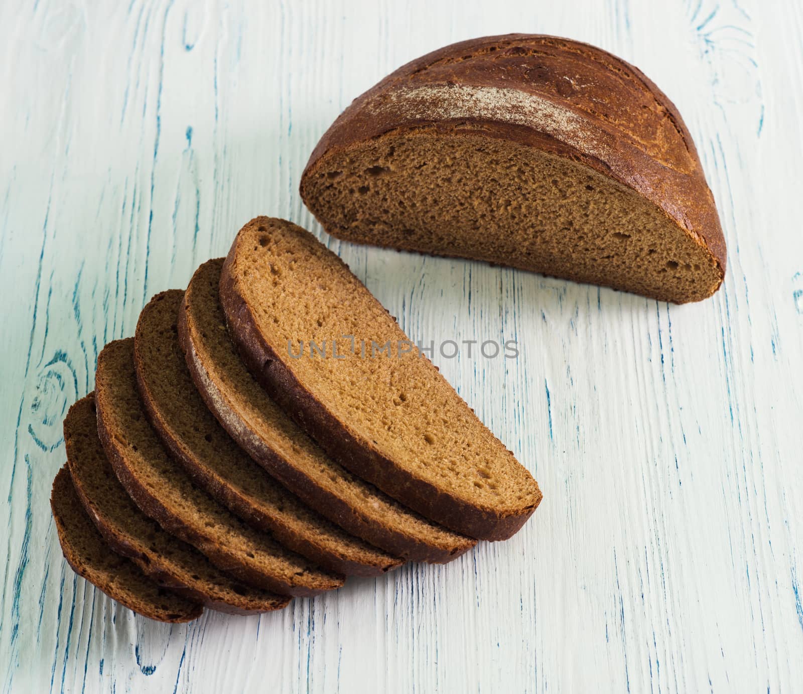 Sliced rye bread on light wooden table
