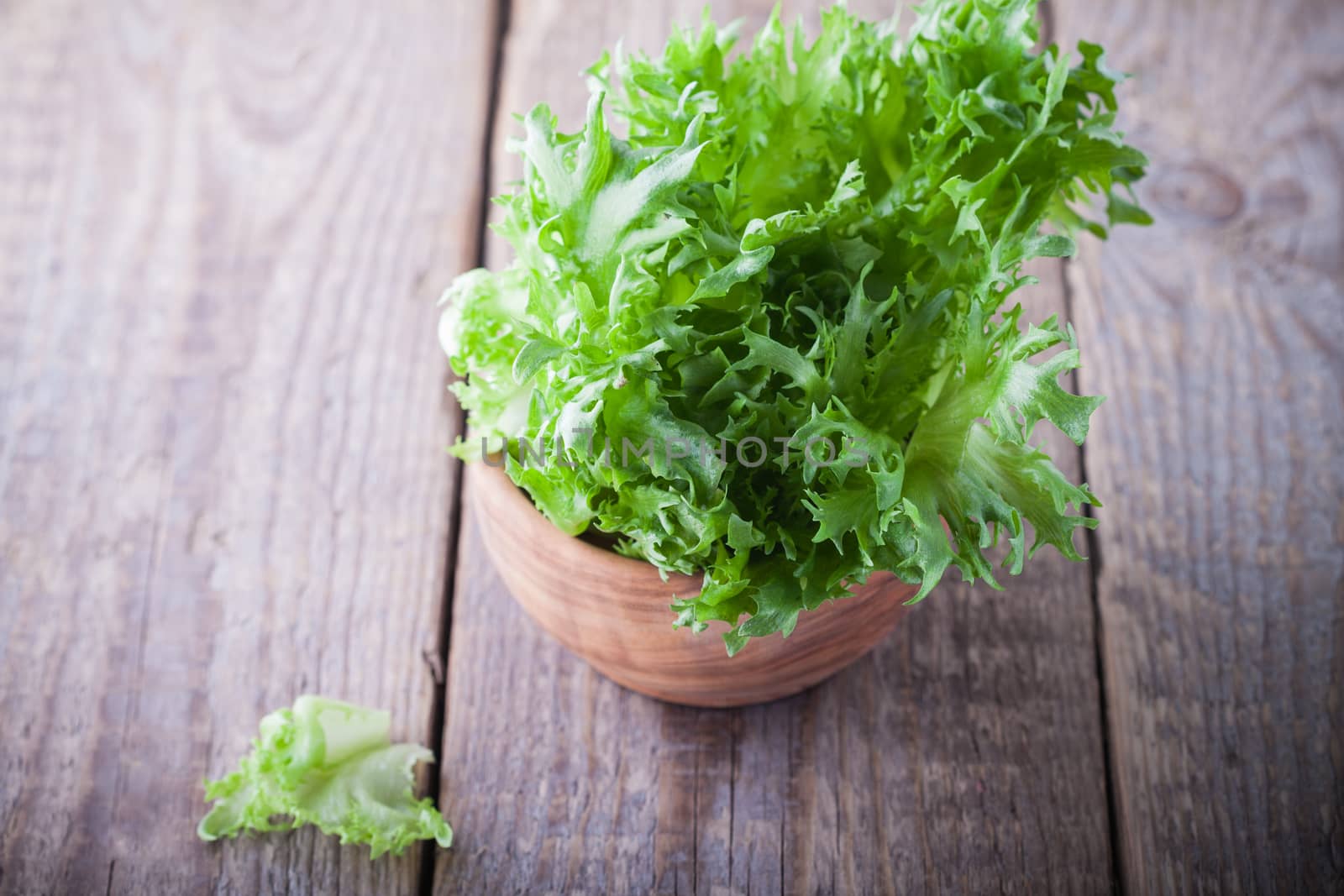 Fresh green lettuce on a wooden table.
