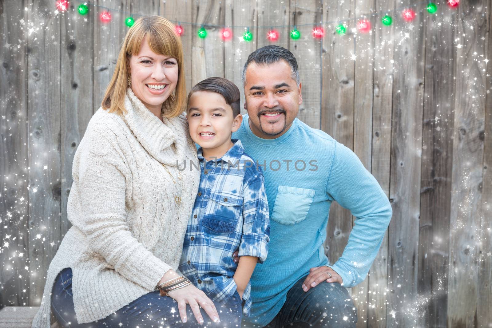 Happy Young Mixed Race Family Portrait Outside with Christmas Lights and Snow Effect.