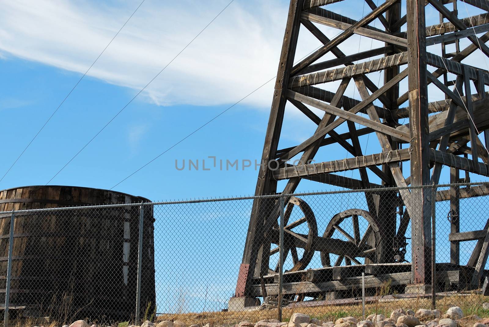 Vintage wooden oil rig displayed outdoors.