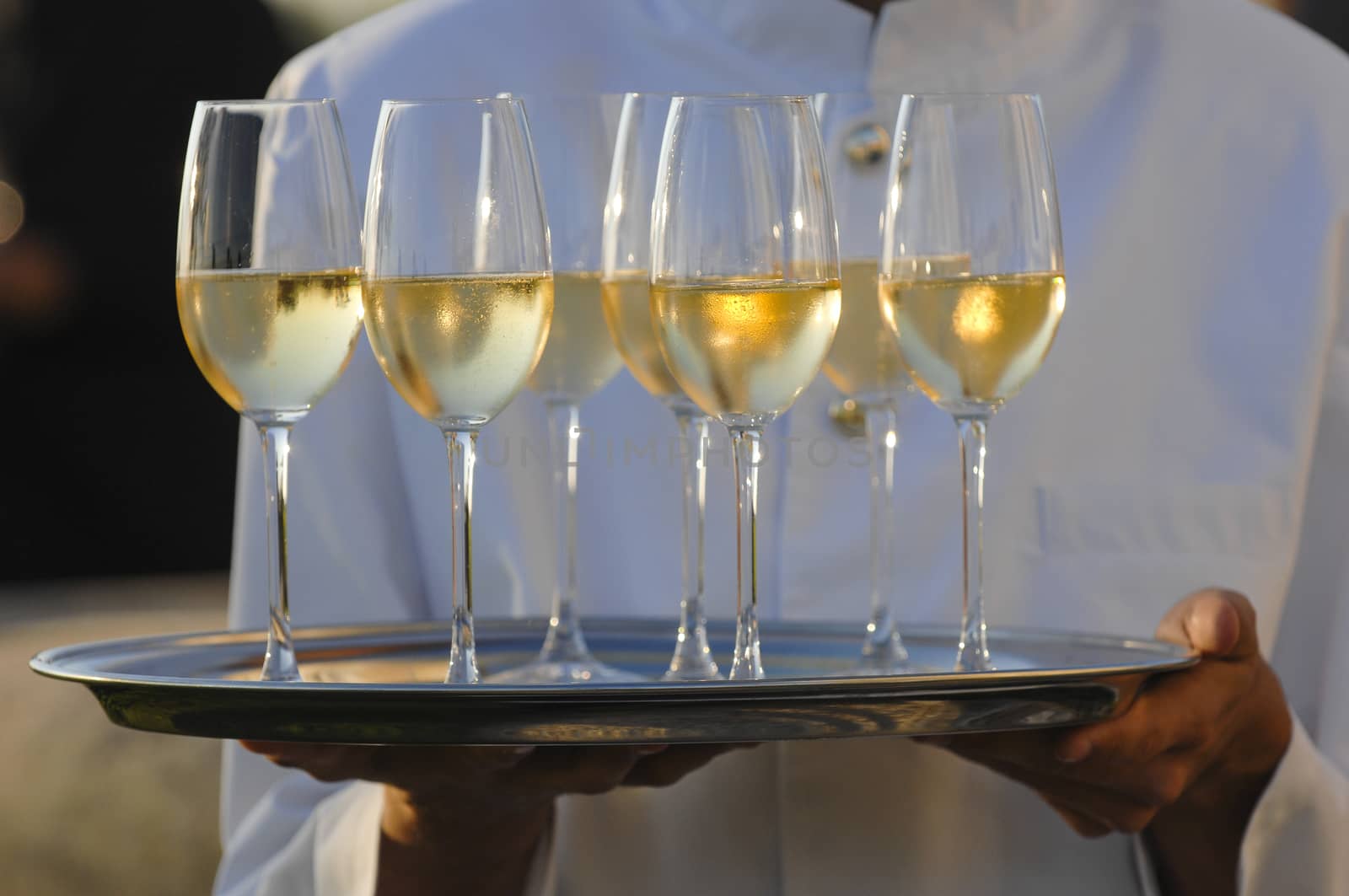Professional male waiter in uniform serving champagne, Dri
