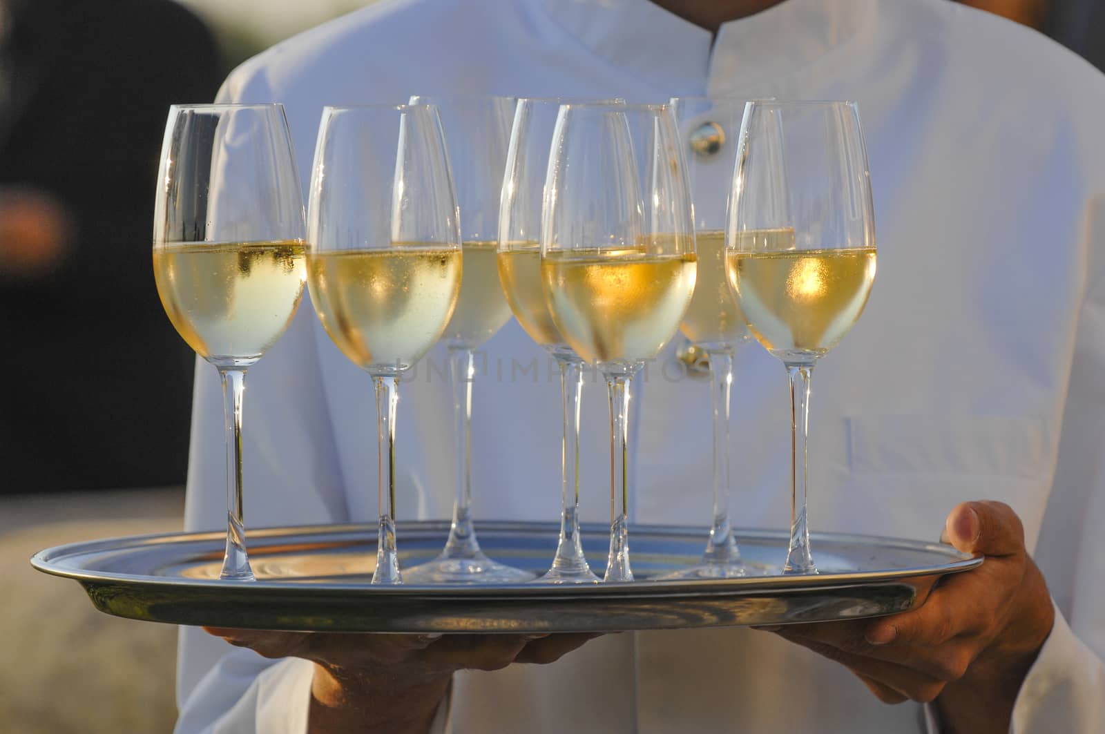 Professional male waiter in uniform serving champagne, Dri