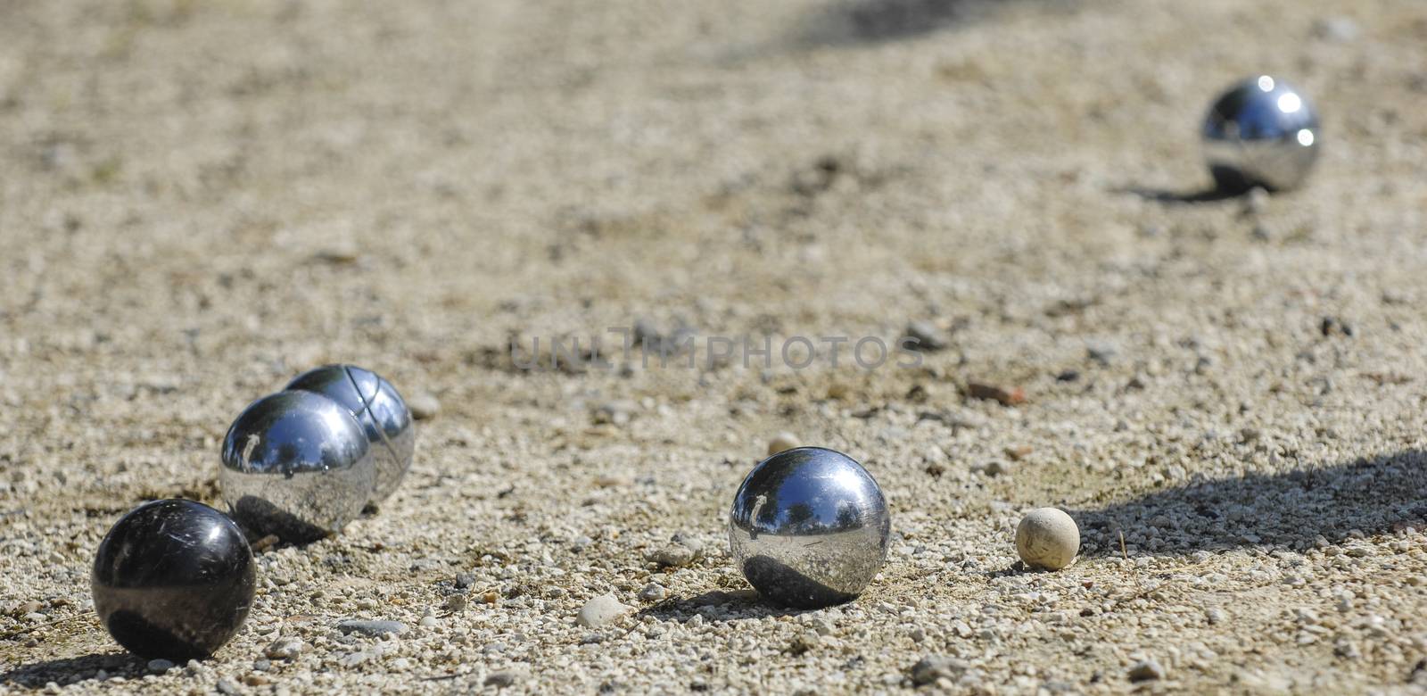 Metallic petanque three balls and a small wood jack, France