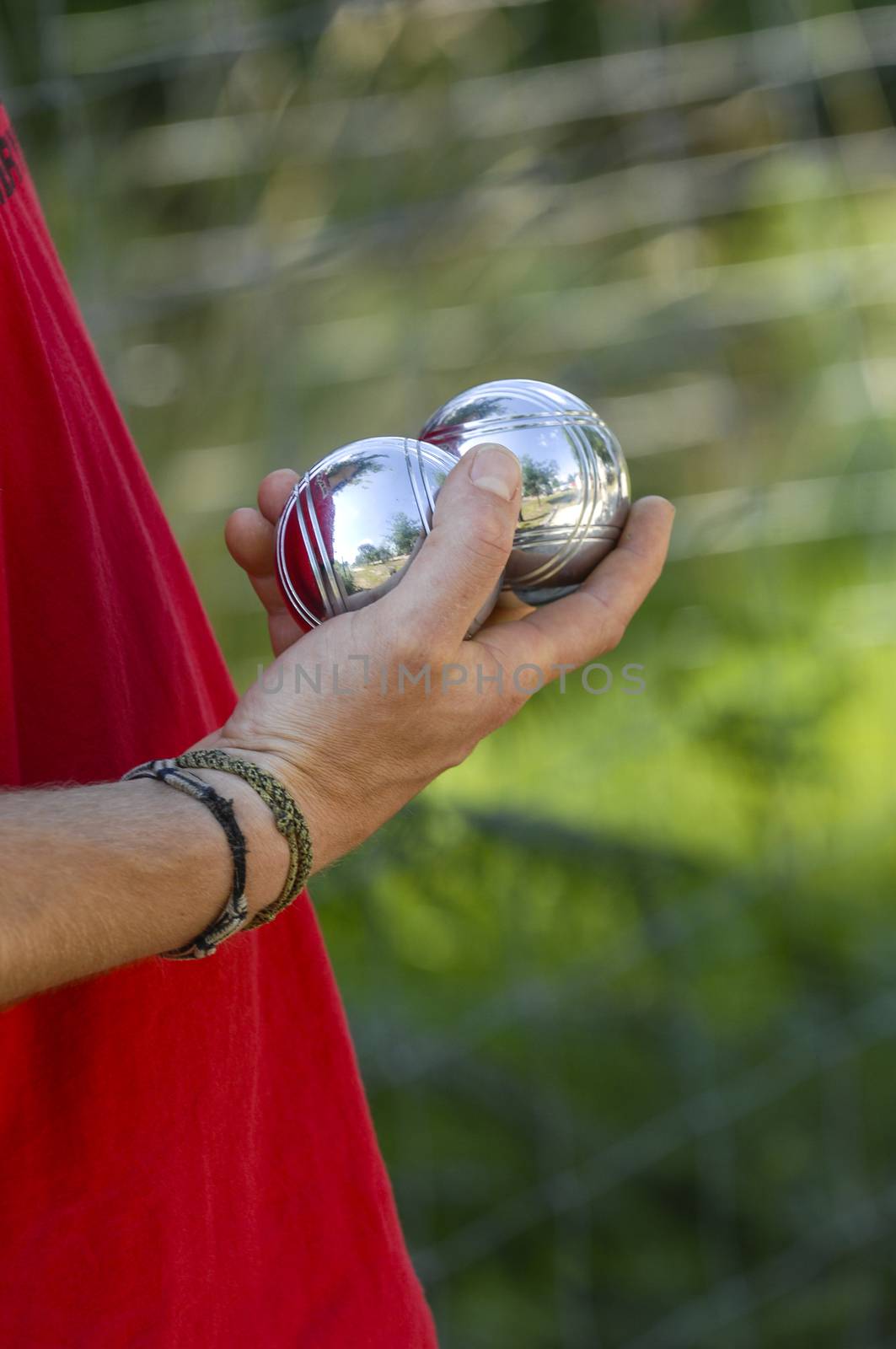 Hand of man holding petanque ball or boule, France