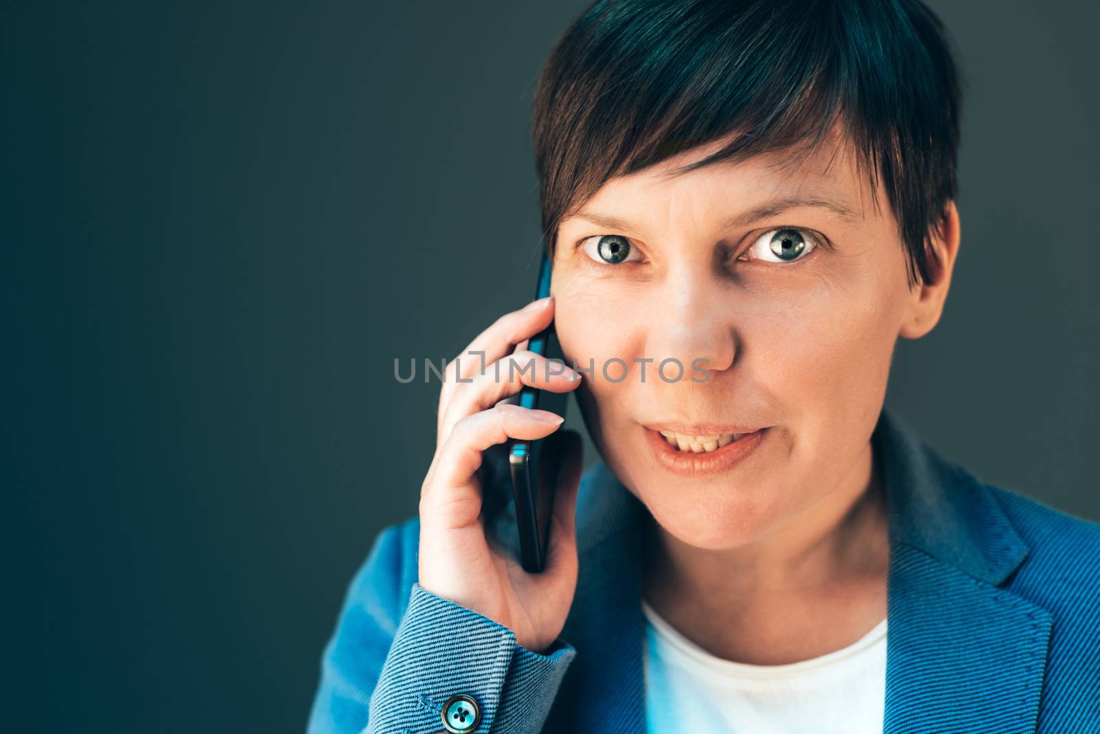 Beautiful businesswoman talking on smartphone by stevanovicigor