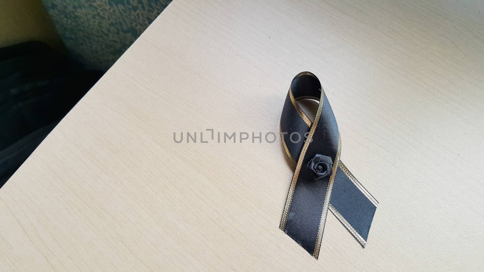 Black bow on the wooden desk. by s3410312