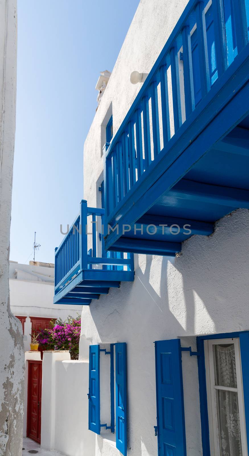 Blue terrace on a white washed walled house in Mykonos in Greece - traditionally Greek