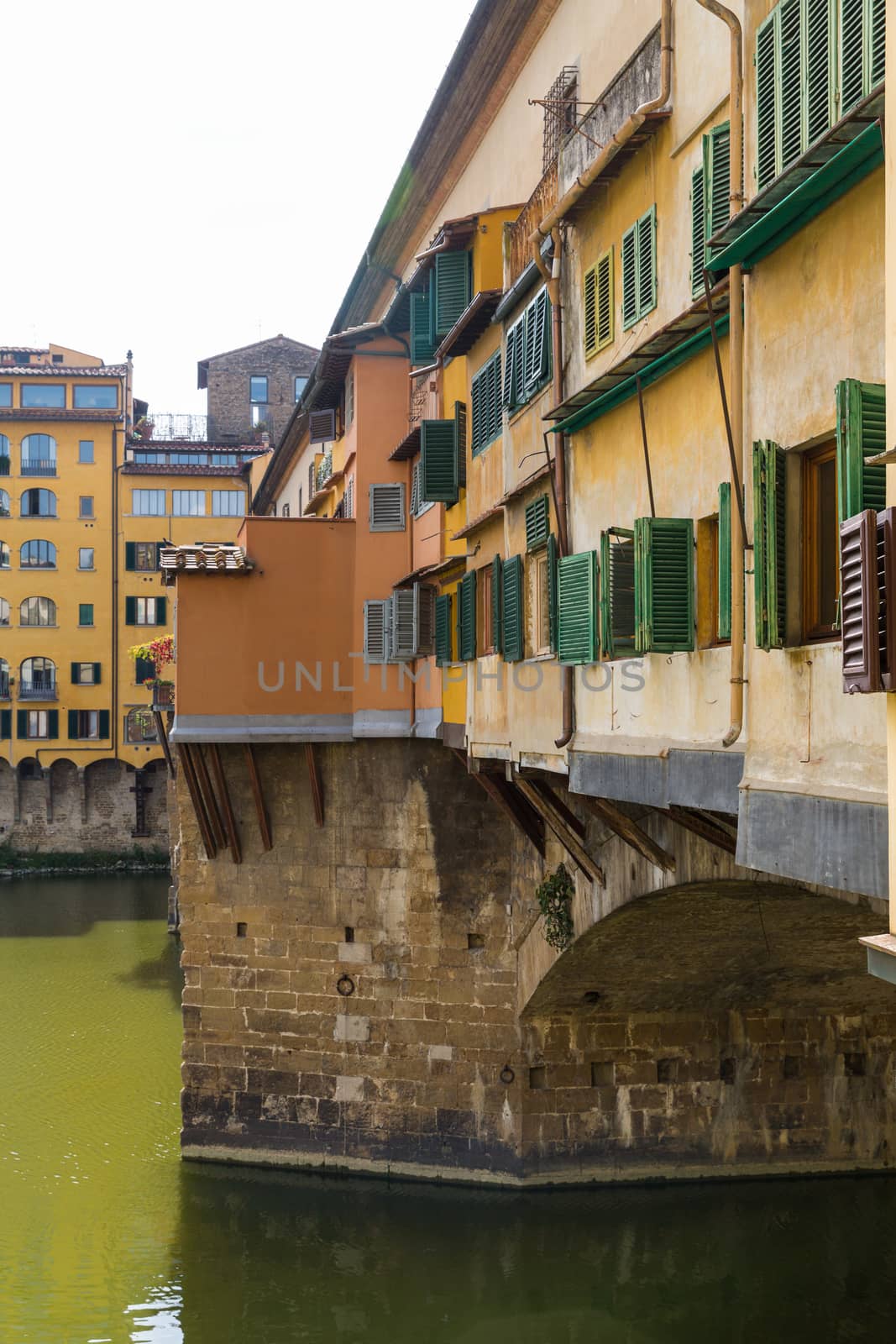 The Ponte Vecchio is a Medieval stone closed-spandrel segmental arch bridge over the Arno River, in Florence, Italy, noted for still having shops built along it, as was once common.