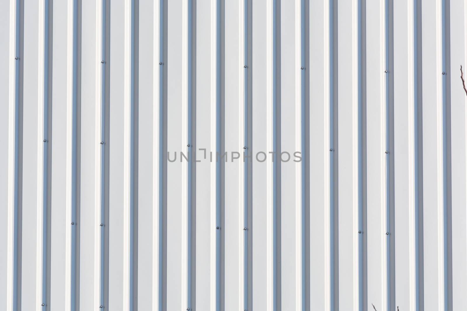 Silver-colored metal wall corrugated sheet metal background.