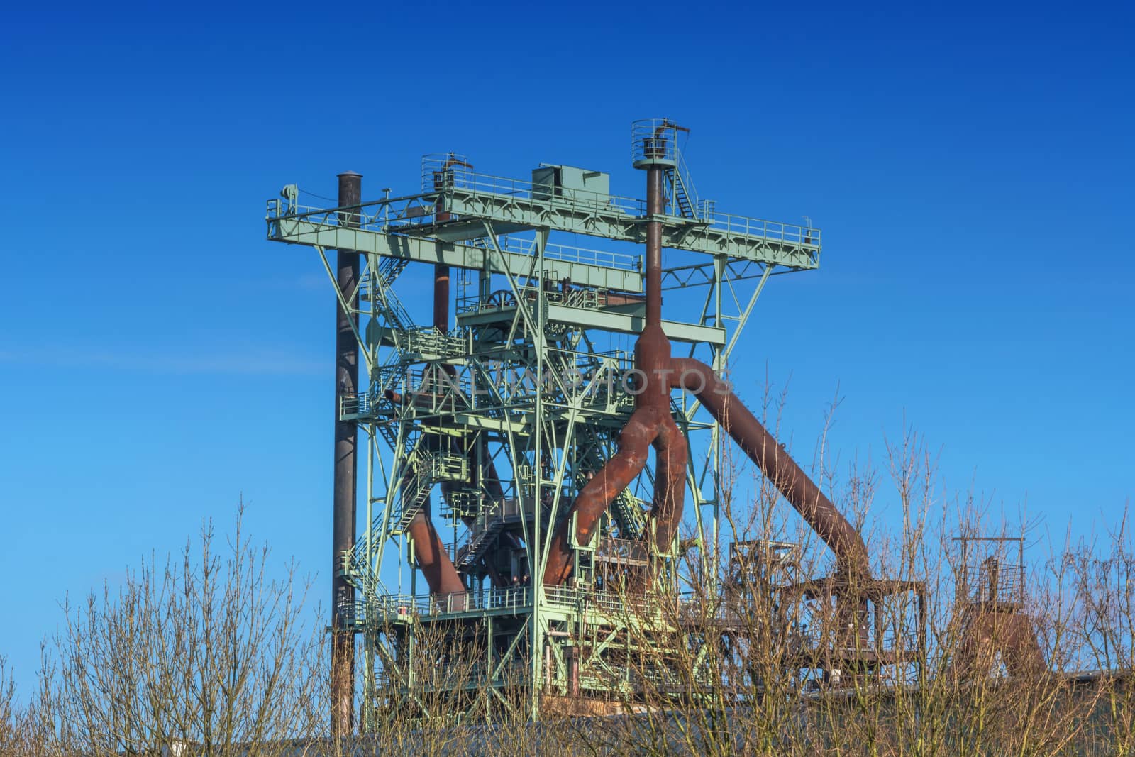 View blast furnace of an old steel mill before blue sky.