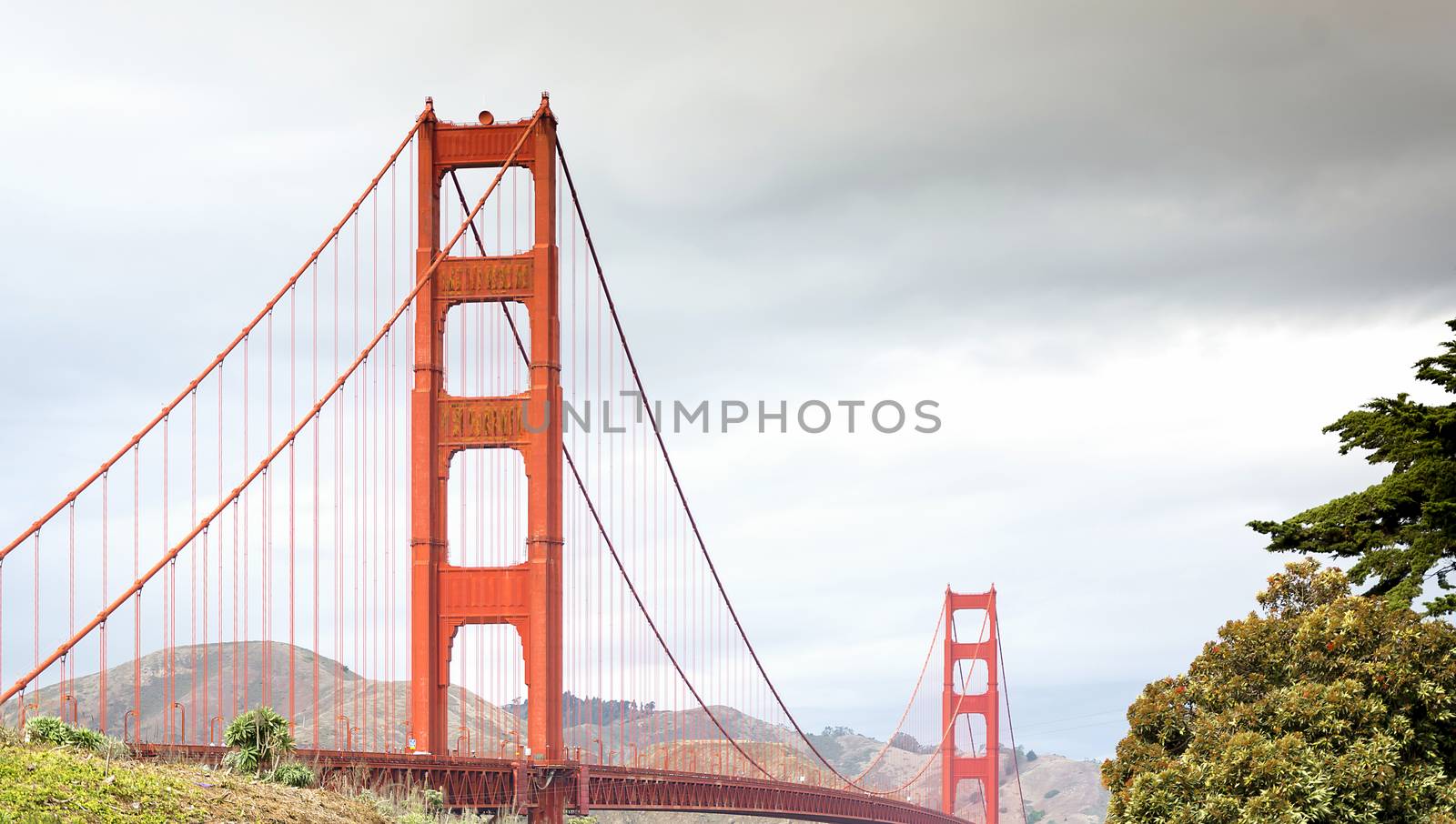 Fog sets over San Francisco with Golden Gate Bridge in foreground