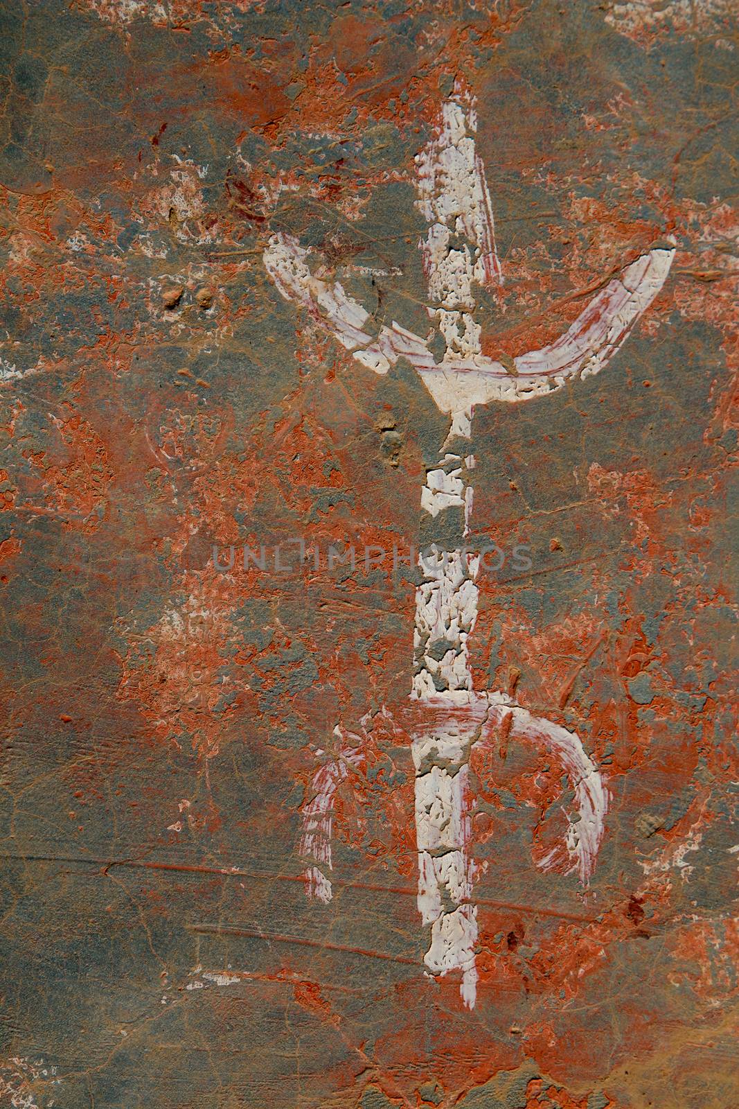 Old wall peeled off into a marble look. Painted white letter Z in berber alphabet, which is a sign of freedom. Morocco.