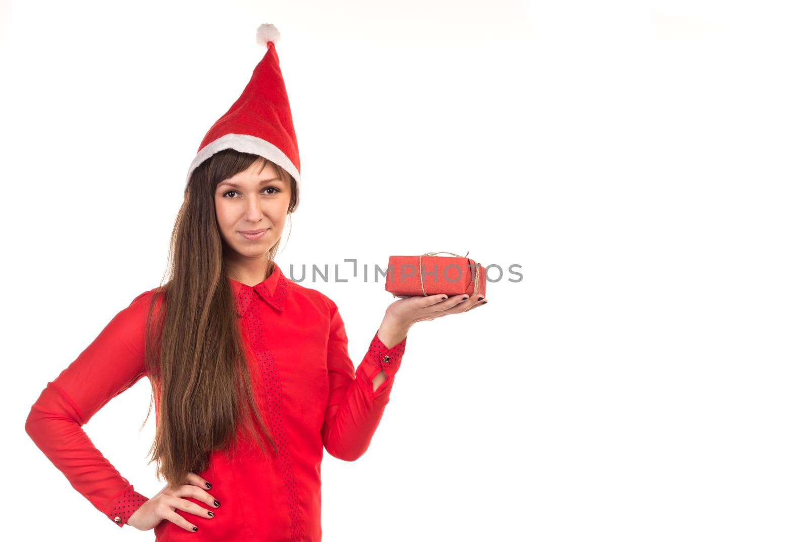 Young long-haired woman in red christmas cap holds red gift box