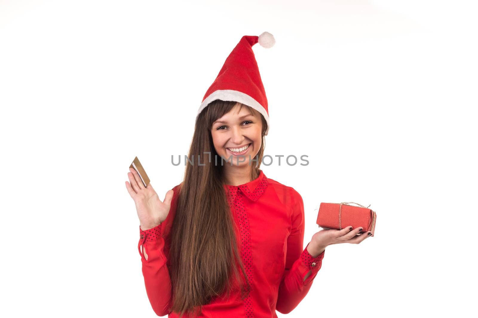 Young long-haired woman in red christmas cap with gold credit card and red gift box