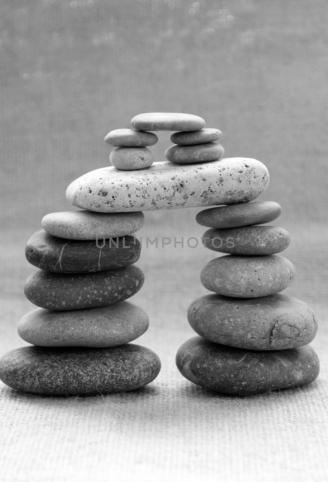Amazing arrangement to make tower from pebble, two stack of stones and more boulder to illustration for bond in family relationship or burden of debt