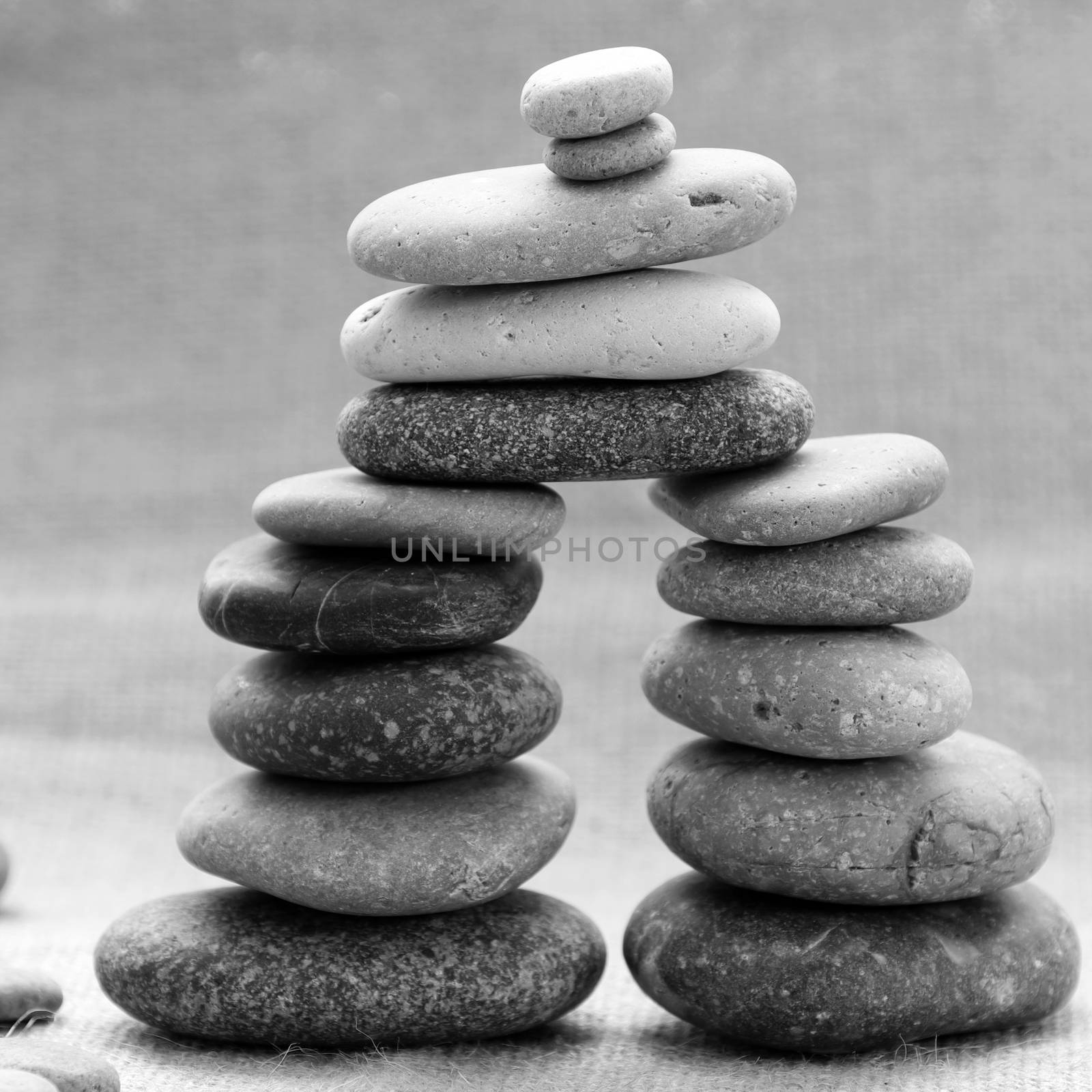 Amazing arrangement to make tower from pebble, two stack of stones and more boulder to illustration for bond in family relationship or burden of debt