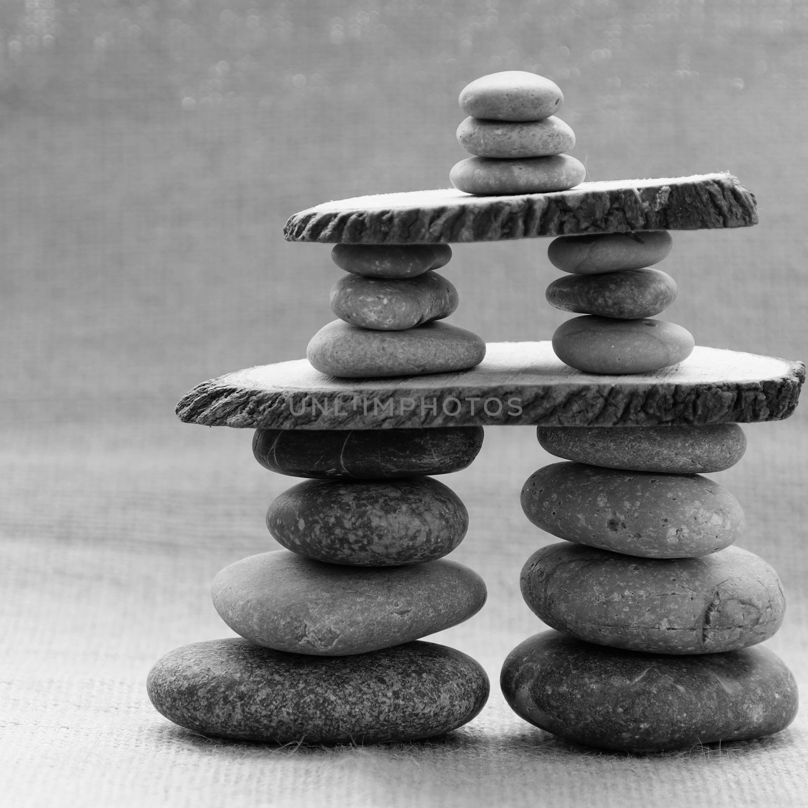 Amazing arrangement to make tower from pebble, two stack of stones and more boulder to illustration for bond in family relationship or burden of debt