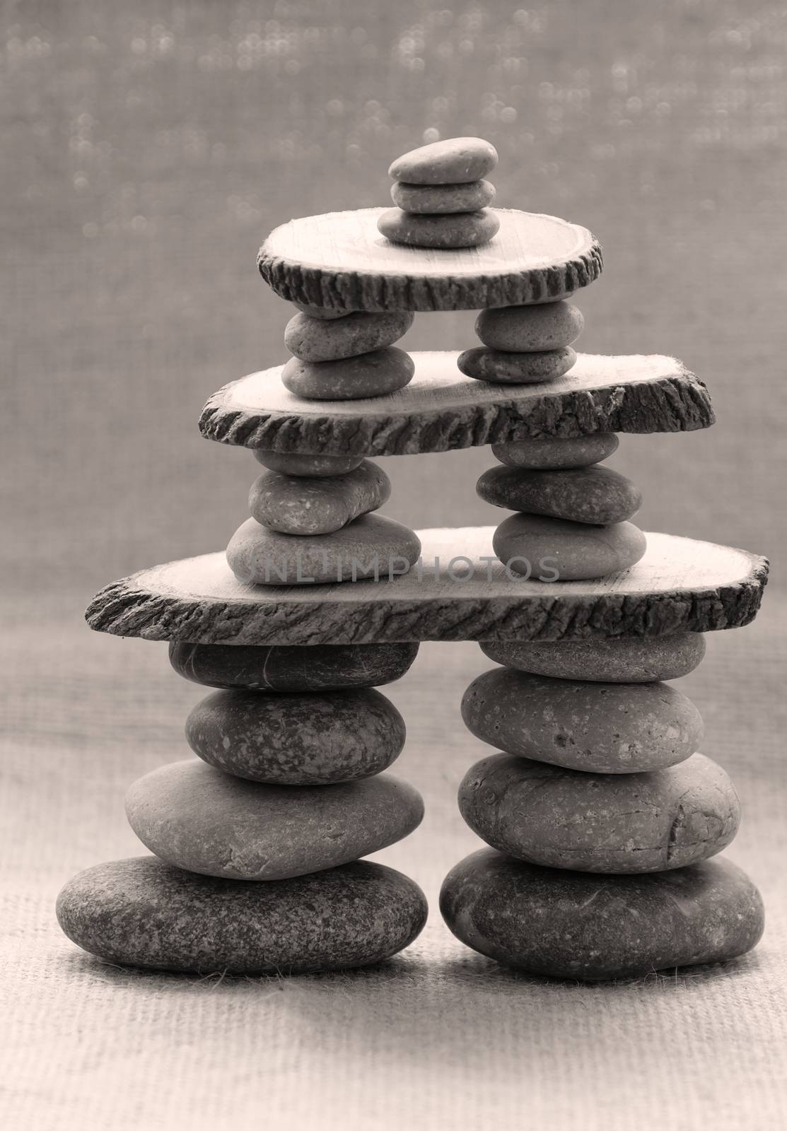 Amazing arrangement to make tower from pebble, two stack of stones and more boulder to illustration for bond in family relationship or burden of debt