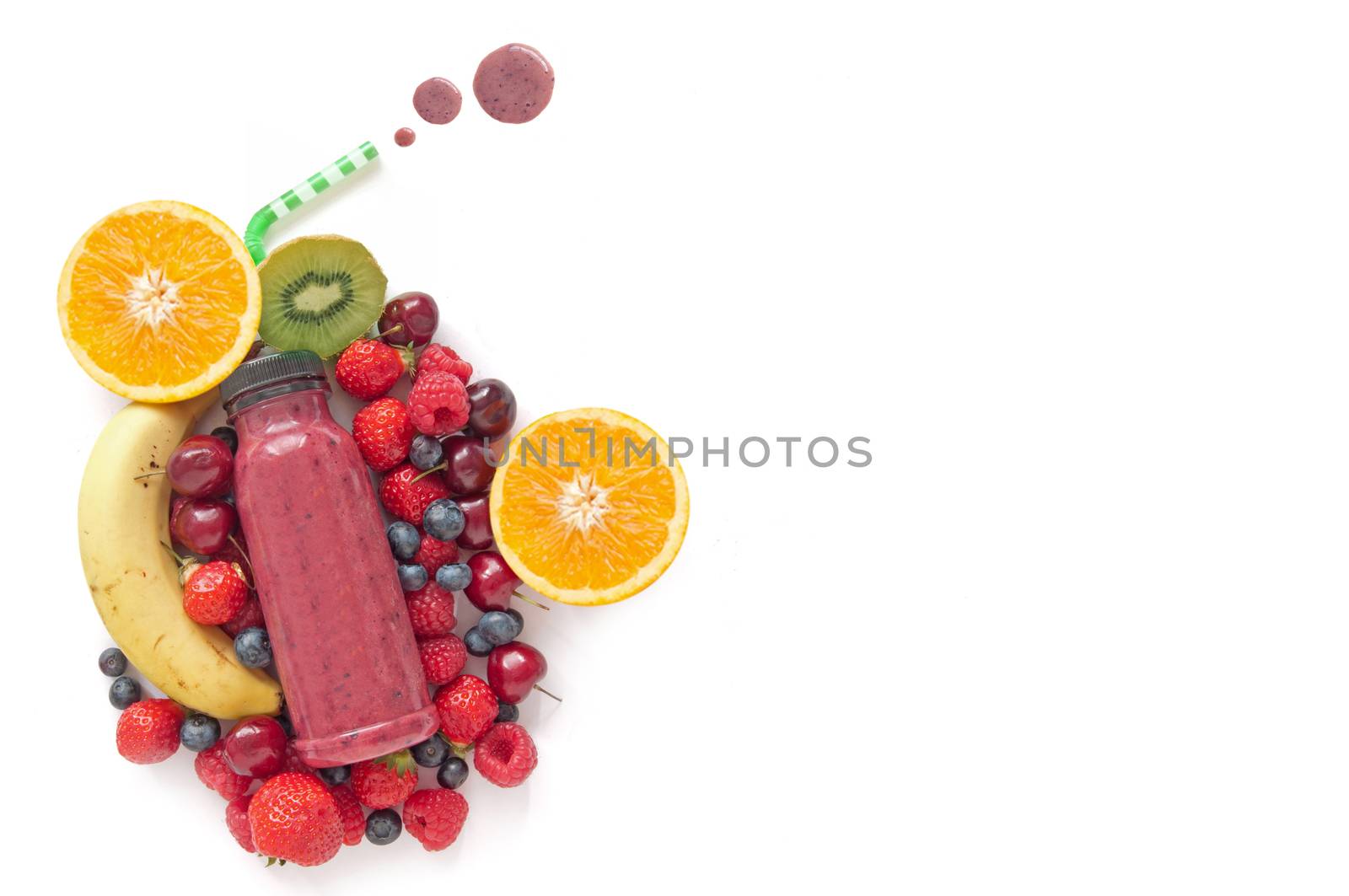 Berry smoothie with raspberries and blueberries over a white background with space for text 