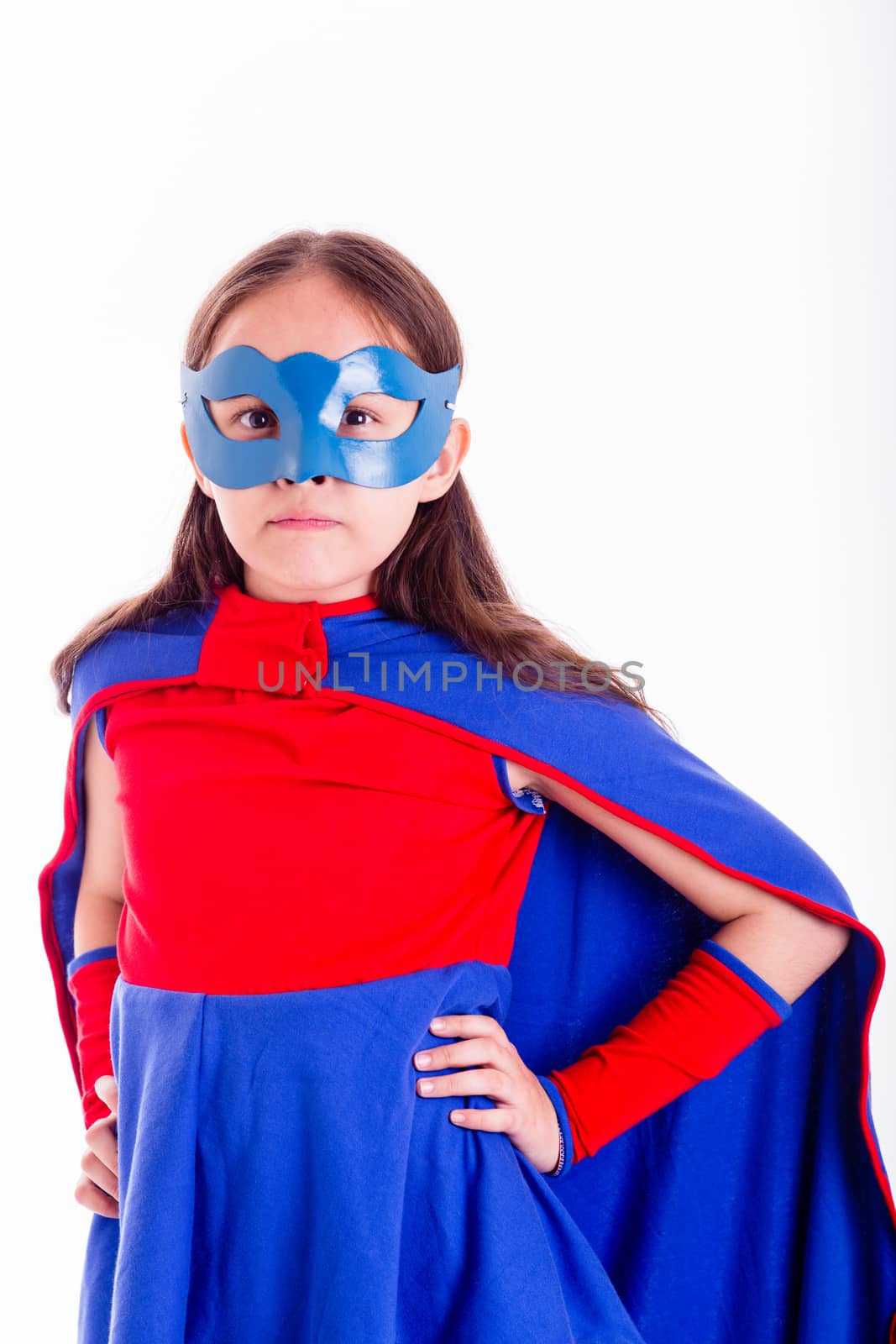 Girl in blue and red superhero costume with hands on hips