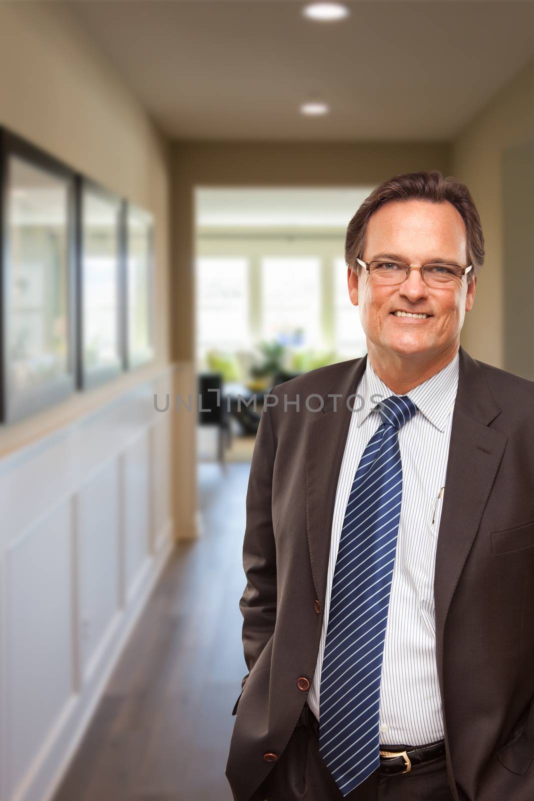 Smiling Businessman In Hallway of New House.