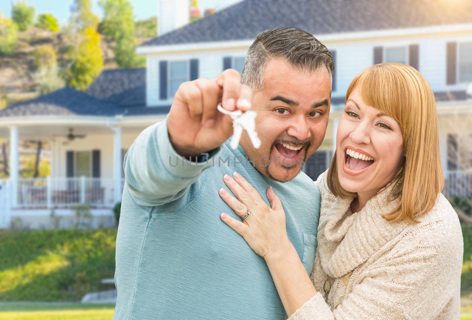 Happy Mixed Race Couple in Front of House with New Keys by Feverpitched