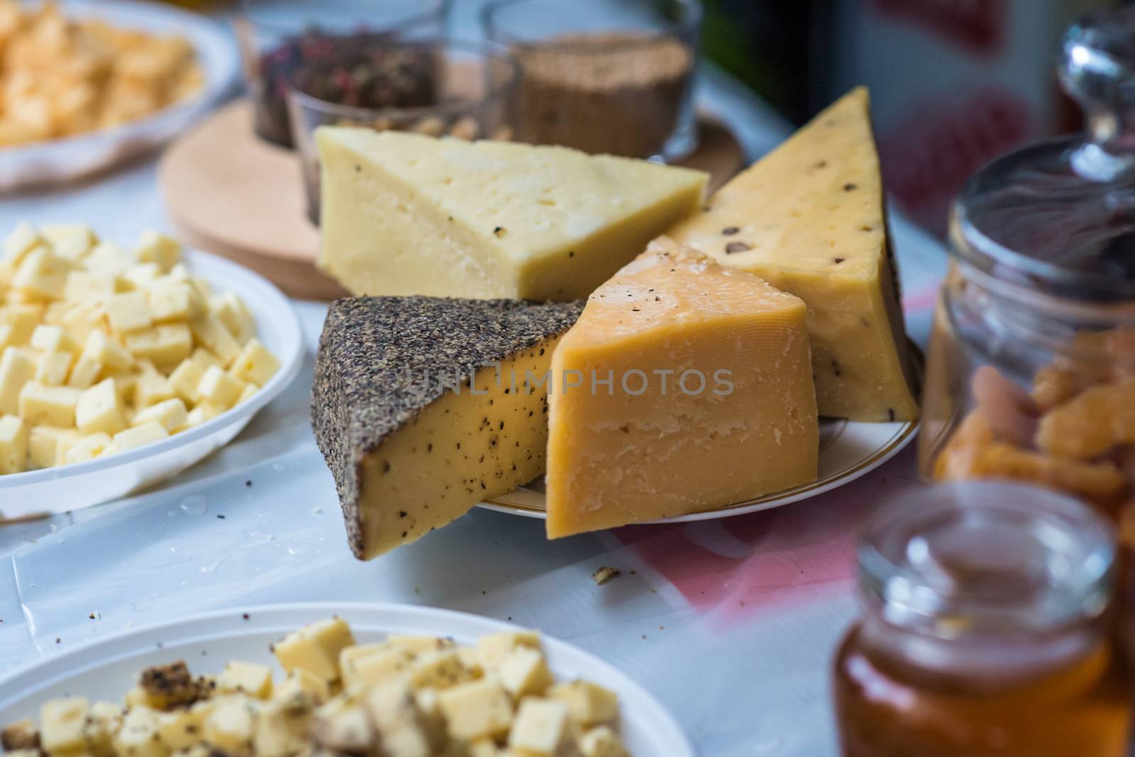 a pieces of hard cheeses on a plate at the exhibition