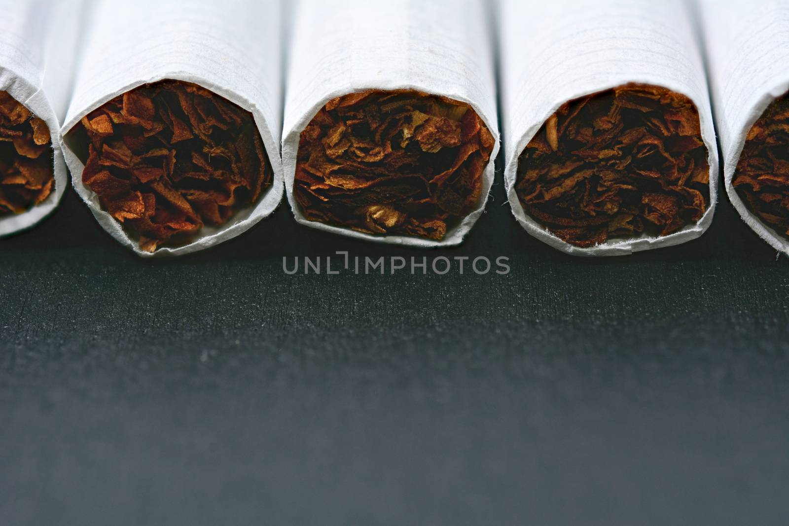 Closeup of cigarettes on black wooden table