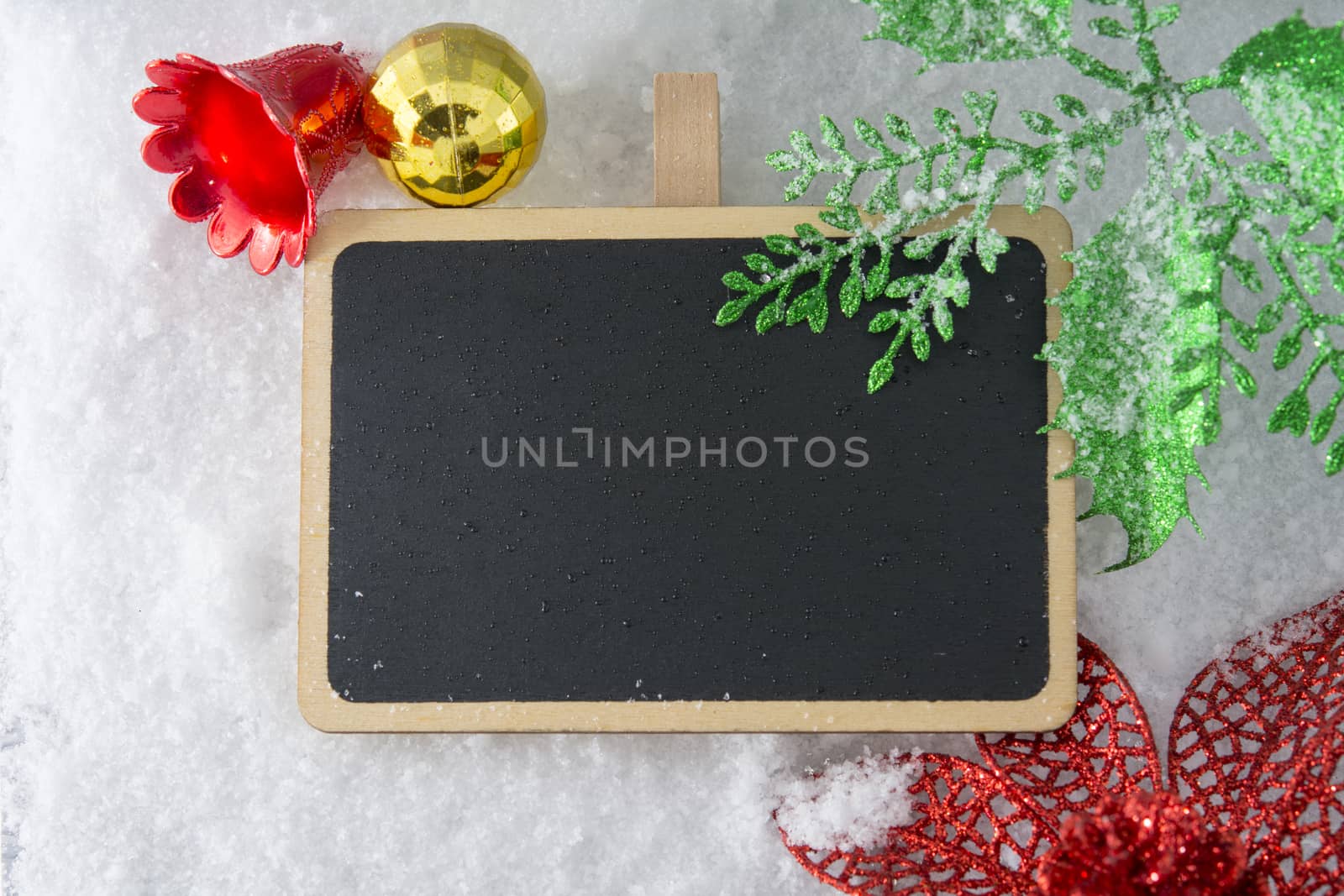 Blank blackboard on snow with Christmas decoration by ipuwadol