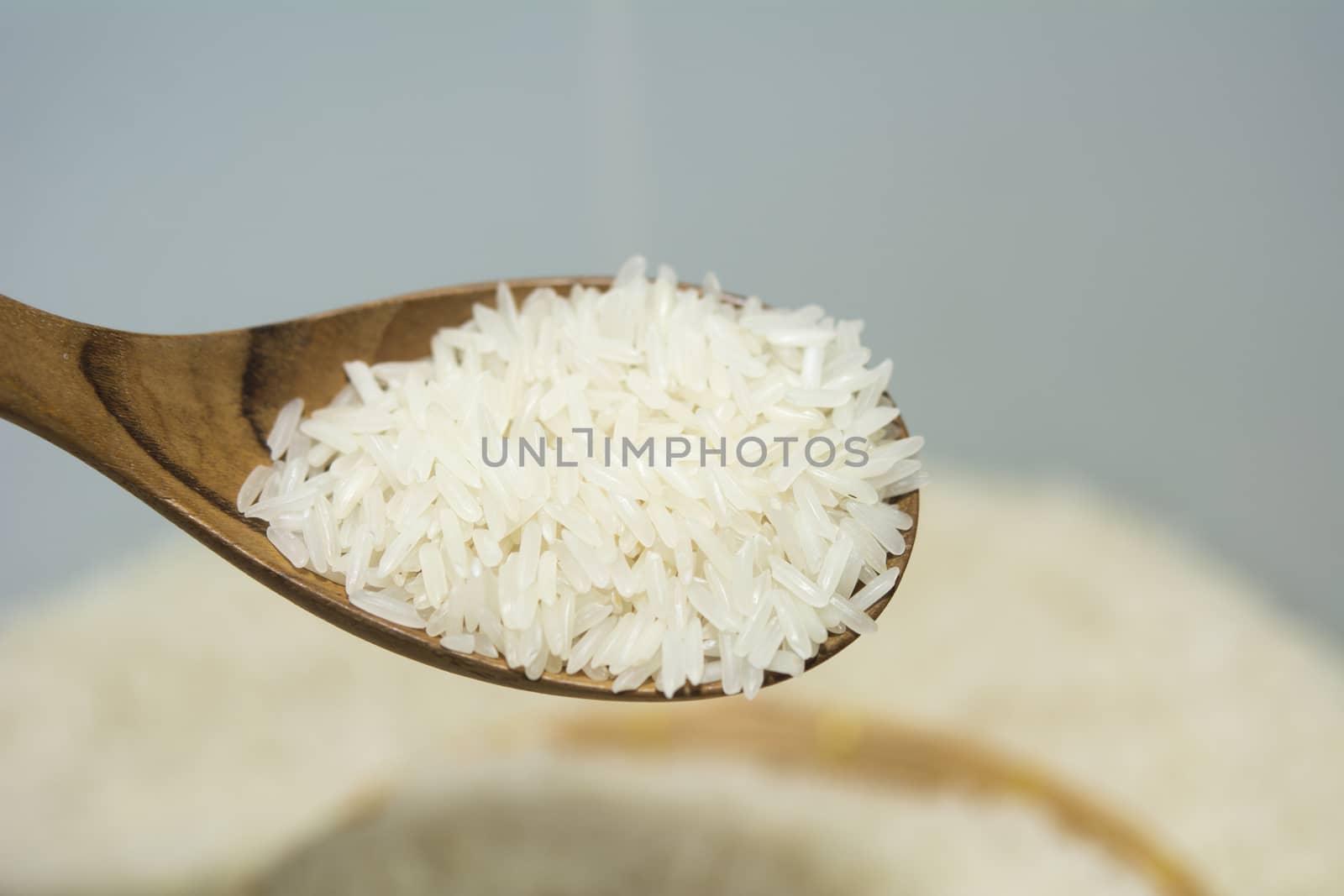 Pouring thai jasmine rice from spoon by ipuwadol