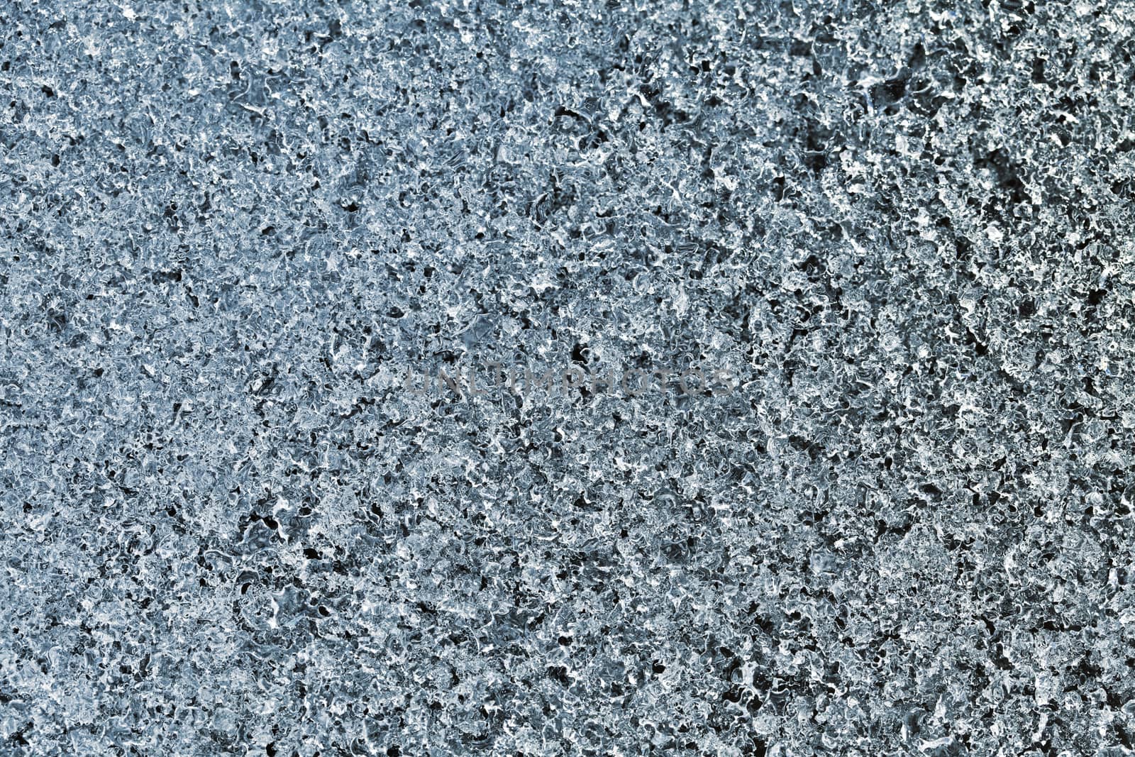 Block of blue smooth melting ice, close-up