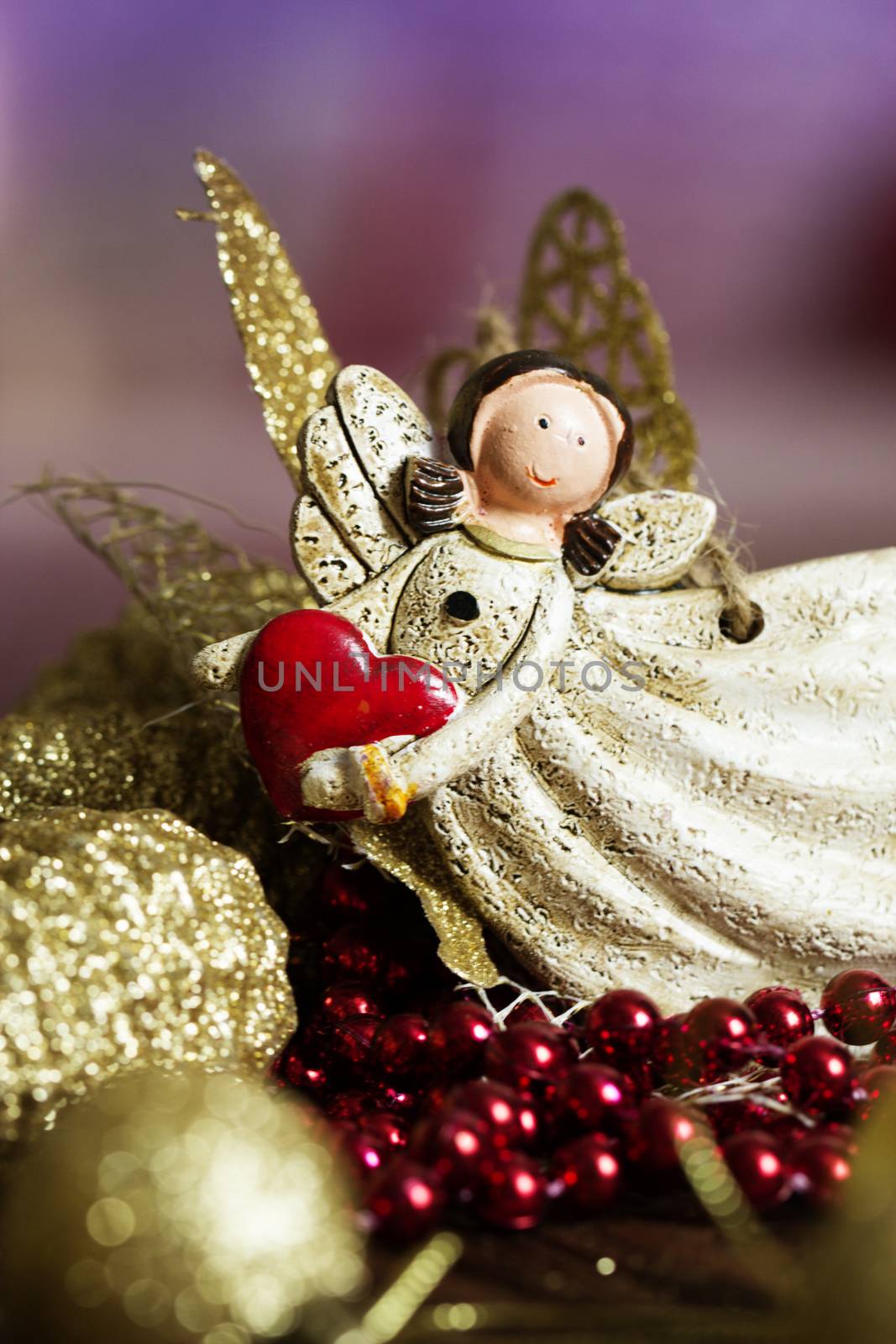 vintage toy angel.Angel toy with a heart in hand on a Christmas background. Christmas card. Christmas decoration.