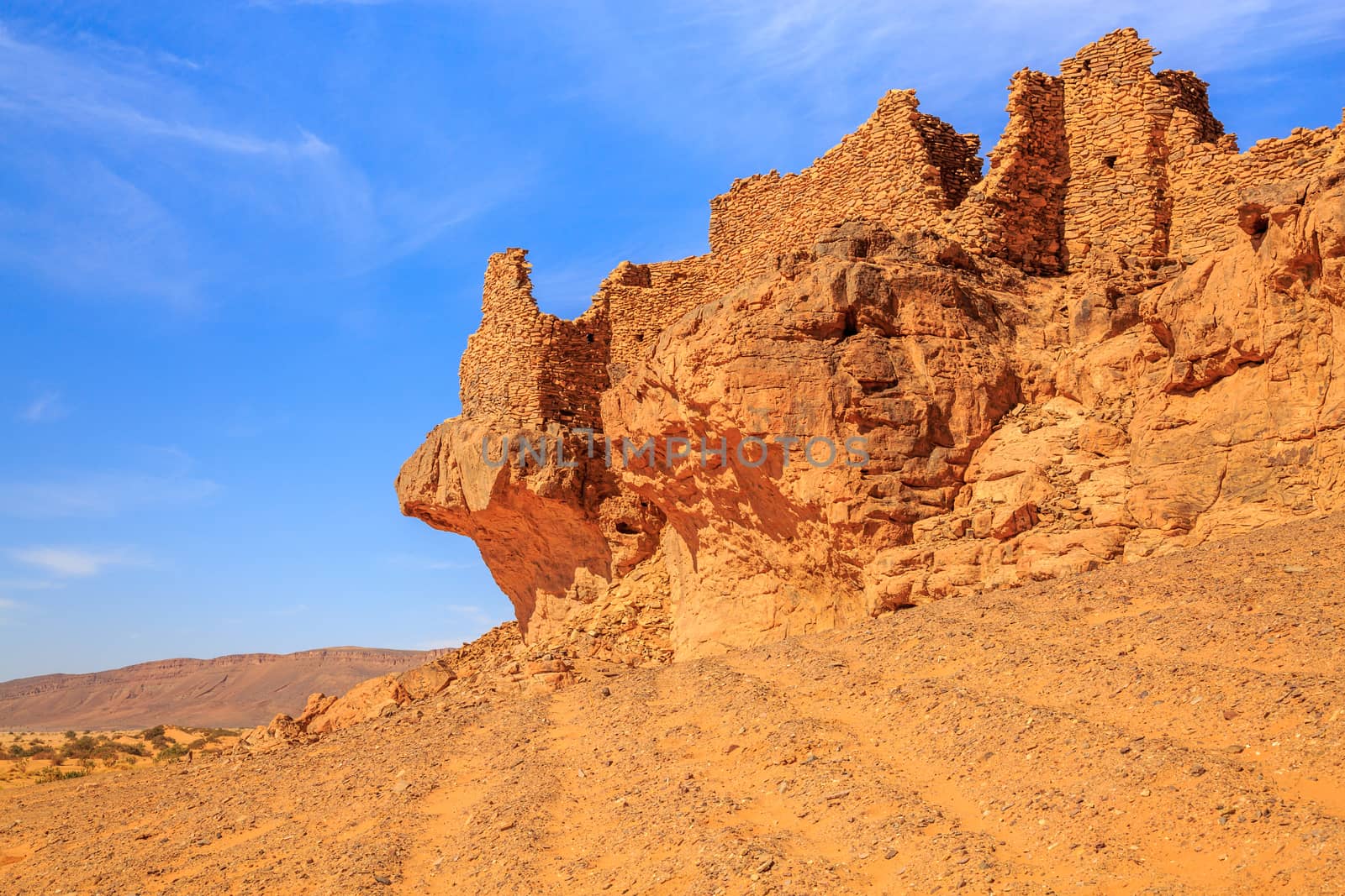 Collapsed wall of castle in moroccan desert